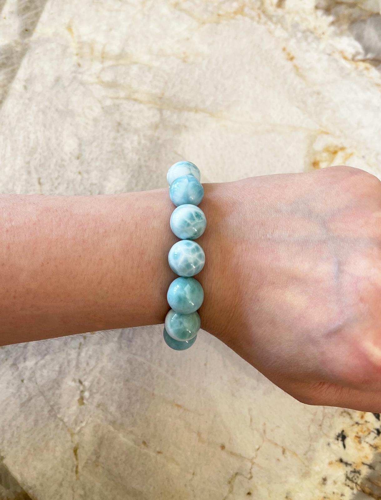 Dazzling round Dominican turtleback larimar (14mm) stretch bracelet made with natural larimar beads . Handcrafted in the USA by Rocat Designs. The larimar beads feature a gorgeous range of blue, green and white tones and the bracelet measures