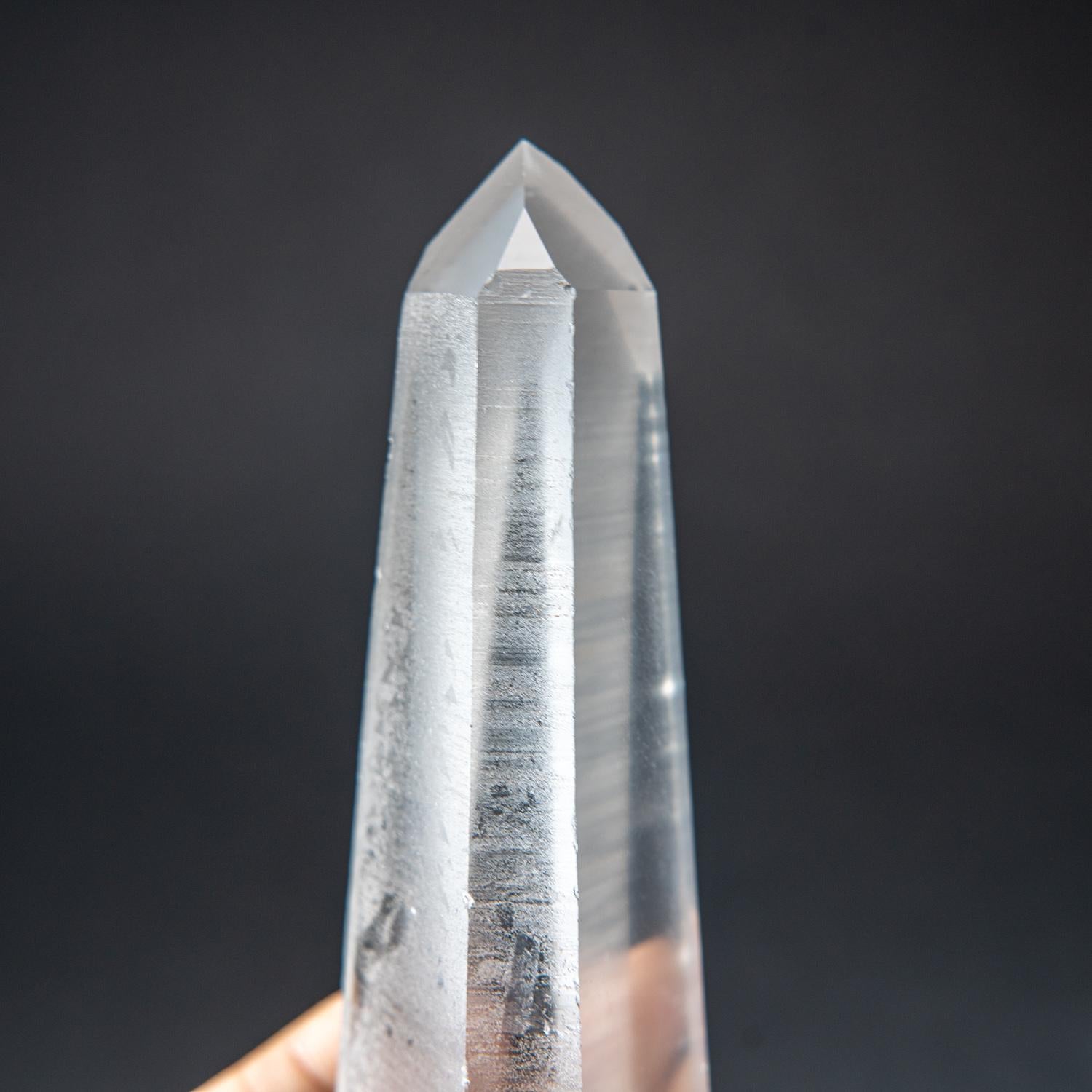 This natural 2.75 lb Brazilian Lemurian Quartz is a large single specimen, featuring transparency and an intact termination. No damage is present, and the crystal is unpolished. Clear Quartz is famously known as the 