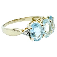 Bague trilogie en or jaune 9 carats avec aigue-marine bleu clair naturelle et diamants 