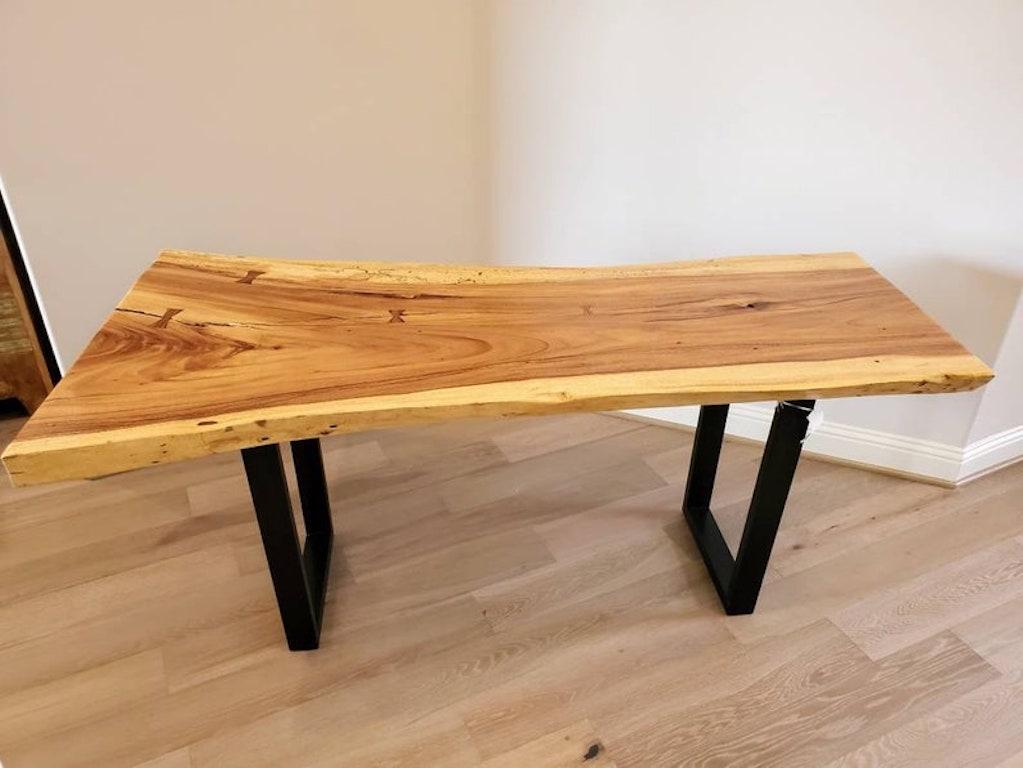 An exceptional natural live edge ash wood slab table. The three inch thick shaped tree slice features beautiful colors and tones, highly figured grain patterns, bow-tie inlay, full of unique character and rustic charm, rising on minimalist
