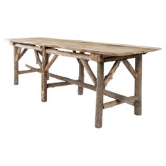 Natural Live-Edge Rectangular-Shape Table Raised Upon Rustic Wooden Trestle Base