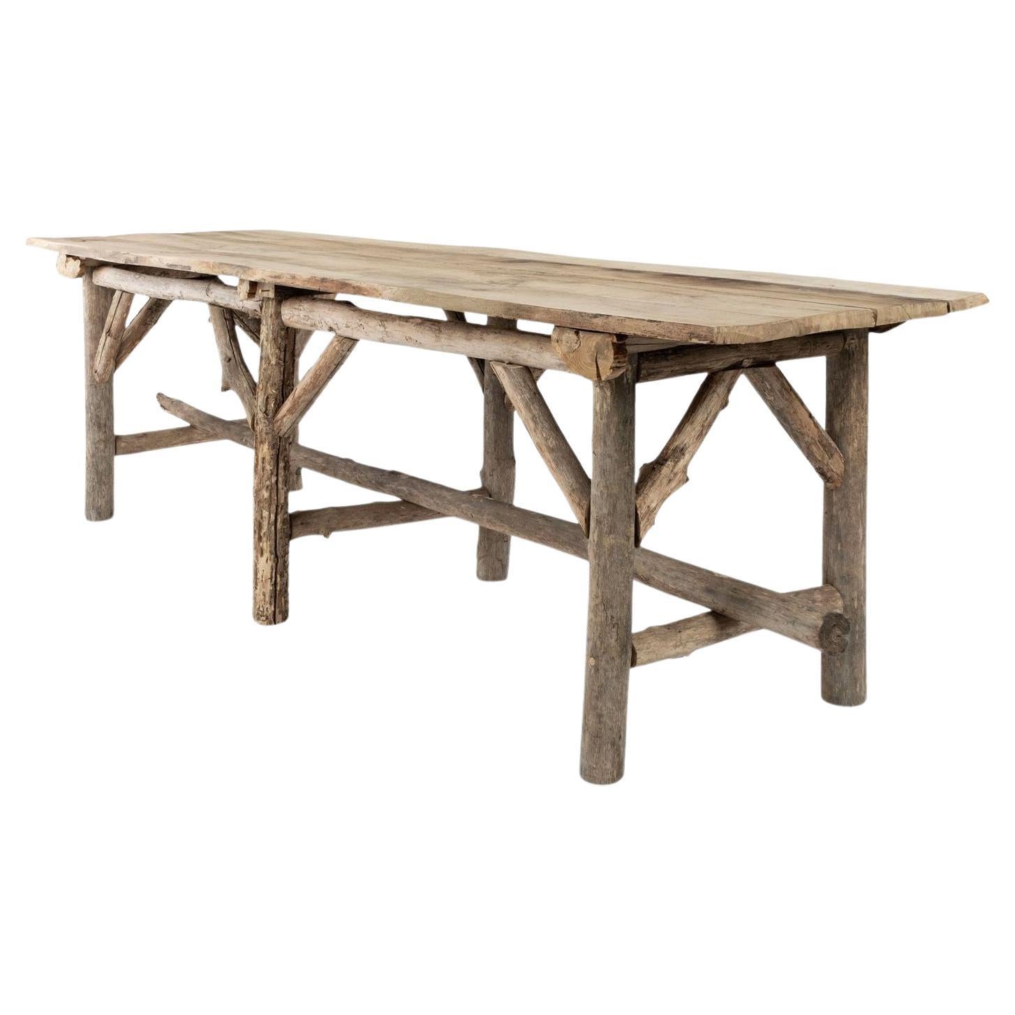 Natural Live-Edge Rectangular-Shape Table Raised Upon Rustic Wooden Trestle Base For Sale
