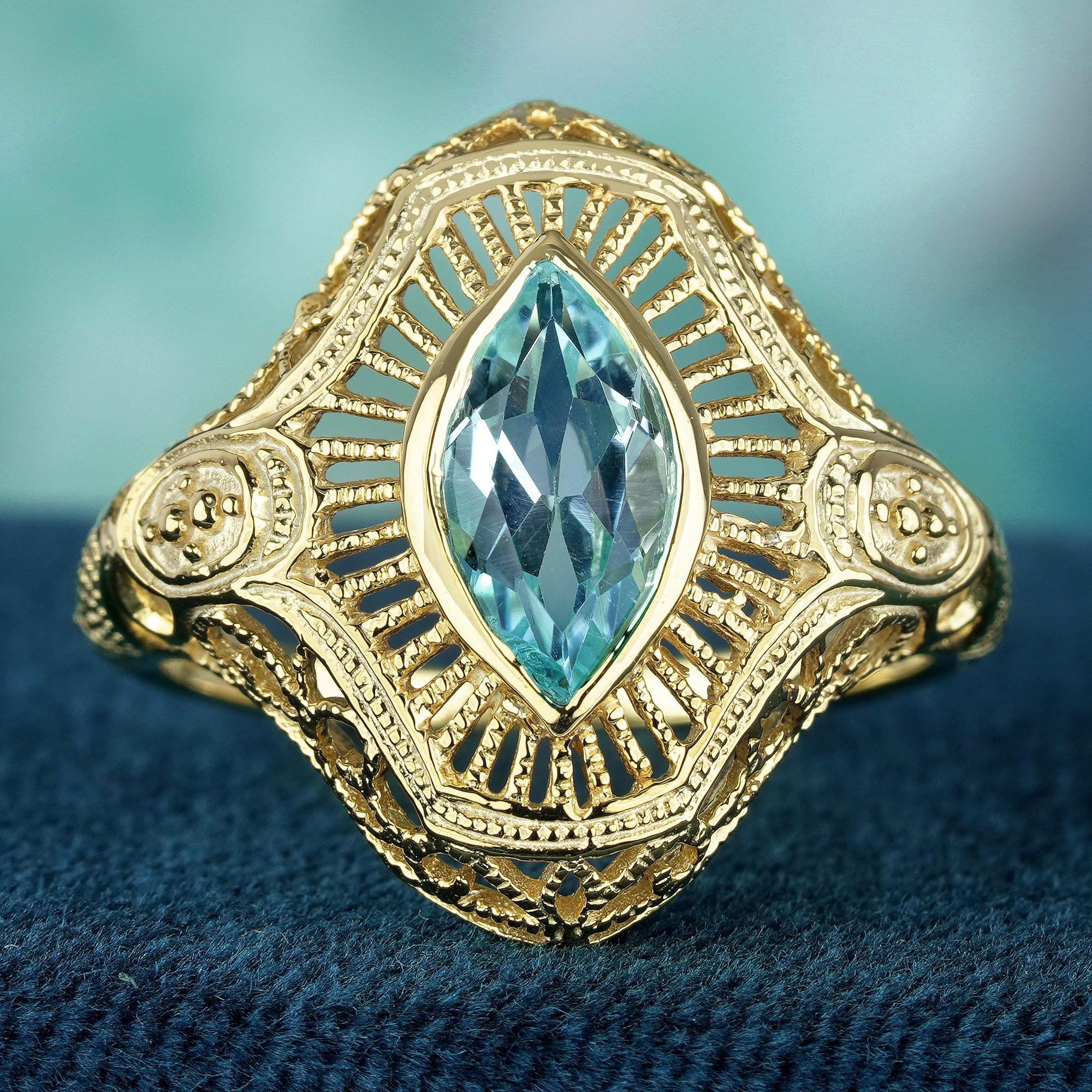 Gönnen Sie sich zeitlose Eleganz mit unserem Marquise-Blautopas-Ring im Art-Déco-Stil. Das exquisite, filigrane Design aus Gelbgold strahlt Raffinesse und Charme aus. Erhöhen Sie Ihren Stil mit diesem atemberaubenden Stück, das zu jedem Anlass einen