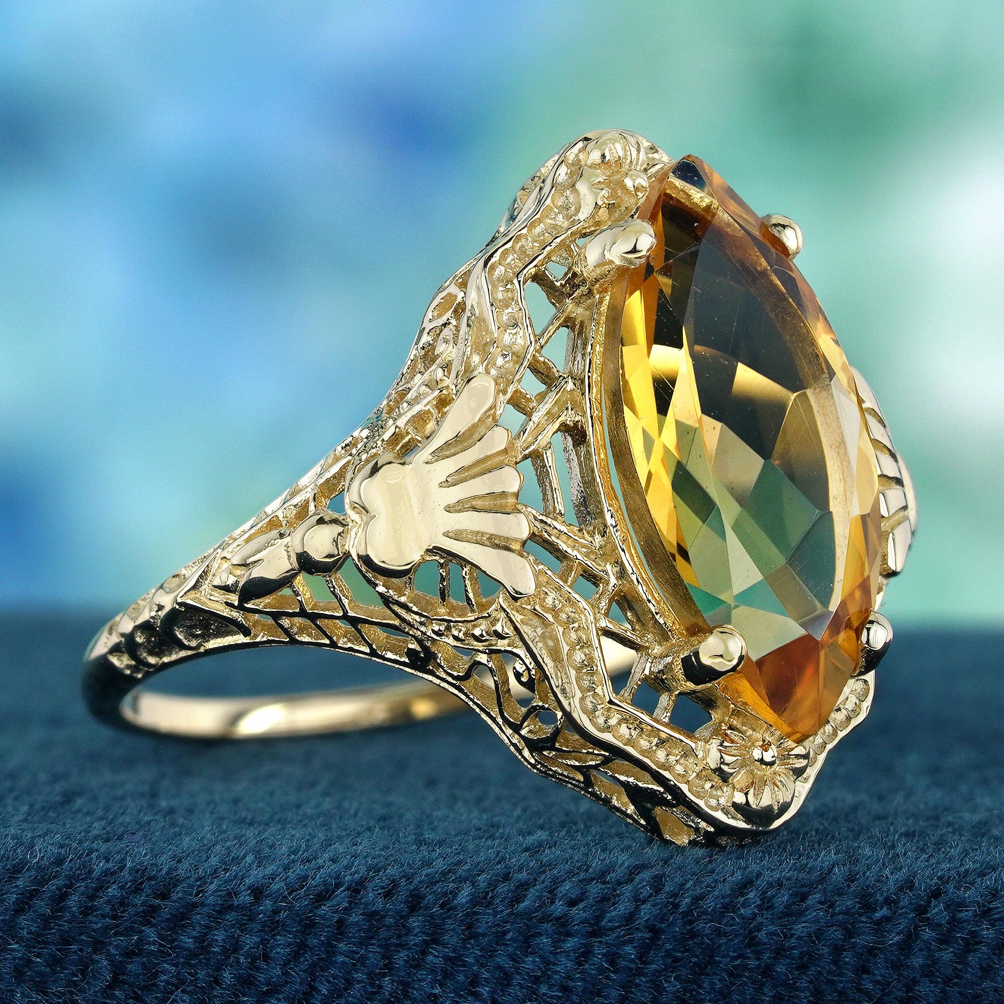 This vintage-inspired ring showcases a captivating marquise shaped citrine gemstone, its warm yellow hue reminiscent of a summer sun. Crafted in gleaming yellow gold, the ring features intricate filigree detailing that adds a touch of whimsical