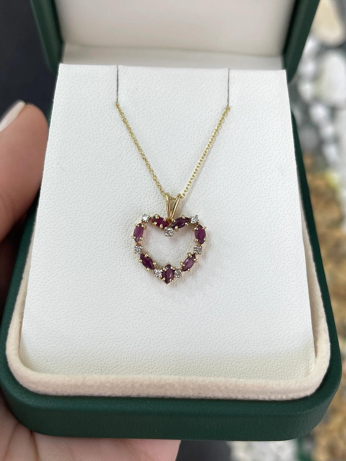 A gorgeous ruby and diamond heart necklace. This charming piece features seven beautiful marquise cut rubies with very good characteristics such as color, clarity, and luster. Between each ruby are micro brilliant round cut diamonds creating the