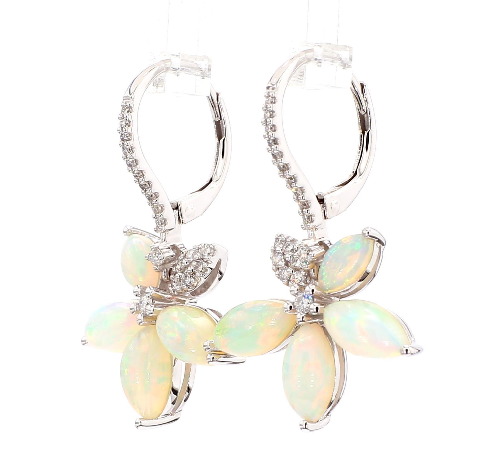 RareGemWorld's beautiful opal earrings. Mounted in a beautiful 14K White Gold setting with natural marquise cut opal's. The opal's are surrounded by natural round white diamond melee. These earrings are guaranteed to impress and enhance your