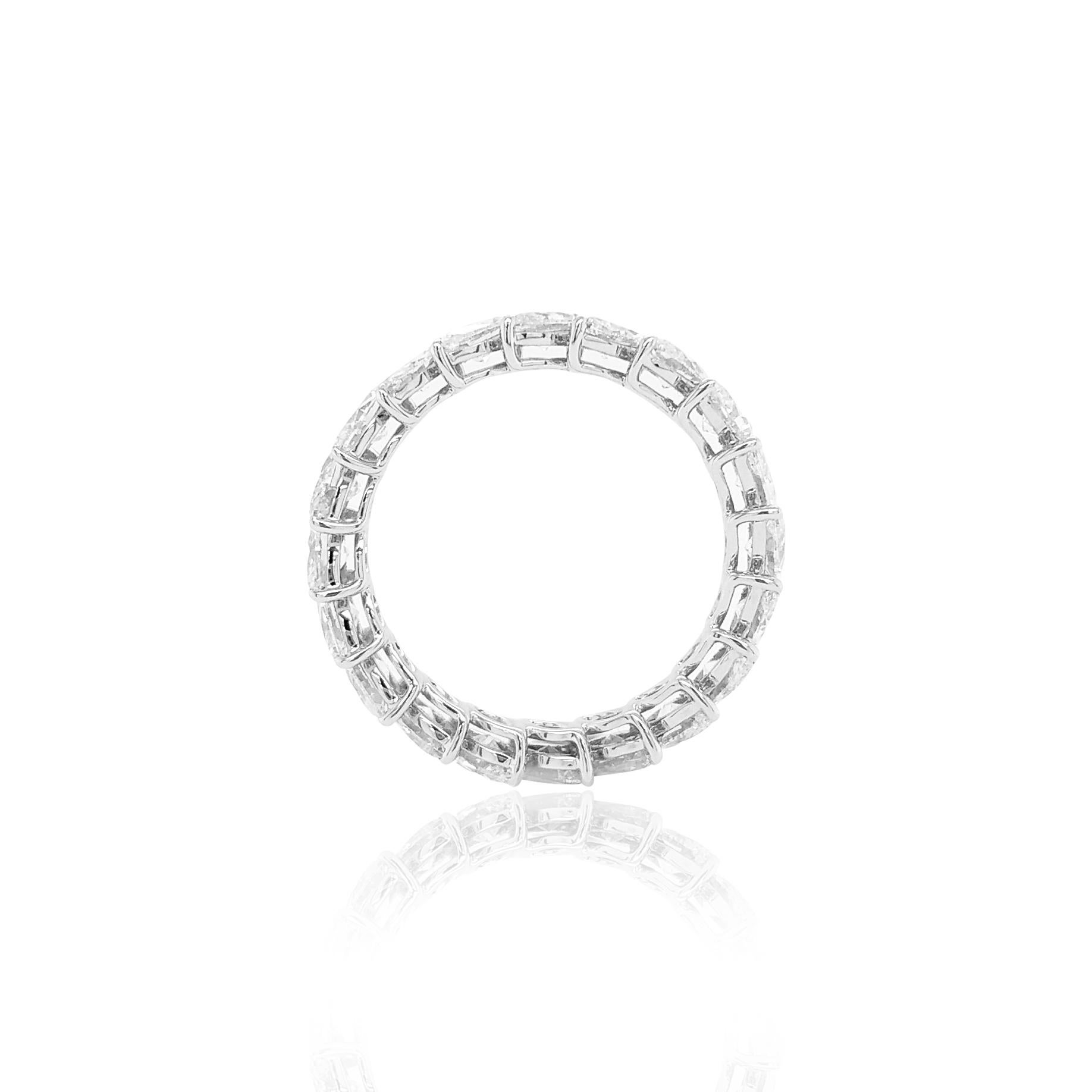 This striking Platinum ring features exceptional quality of the same color, shape, and size natural Marquise shape White Diamonds surrounded the ring, delicate halo of scintillating White Diamonds provide a touch of eternal love. This piece is truly