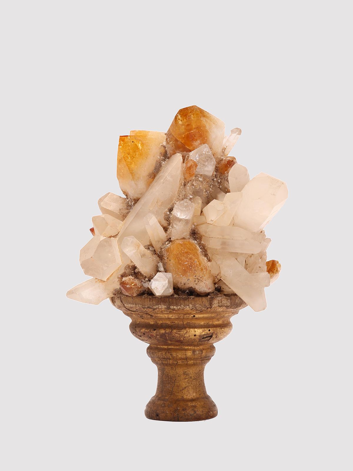 A Naturalia mineral specimen. White and smoke quartz crystals mounted over a carved gold gilded wooden base. Italy circa 1880.