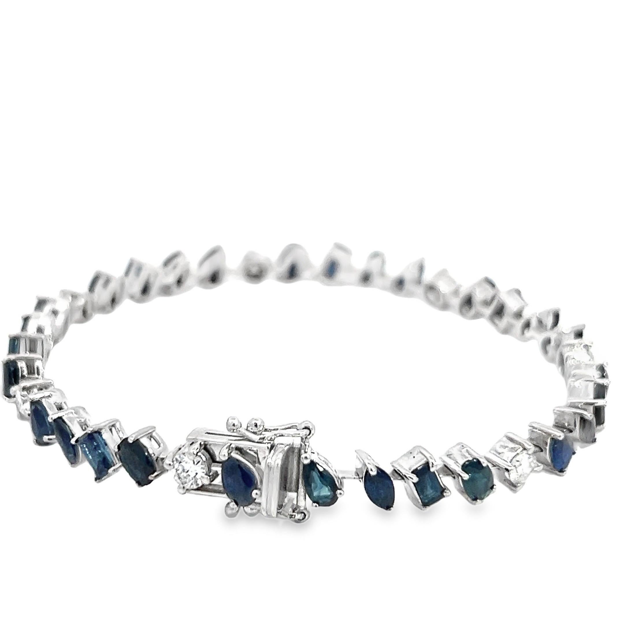Natural Mixed Shape Diamond & Sapphire Bracelet in 14k White Gold.
This exquisite bracelet features a harmonious blend of natural diamonds and mixed-shape blue sapphires, set in 14k white gold. The bracelet showcases a variety of sapphire cuts,
