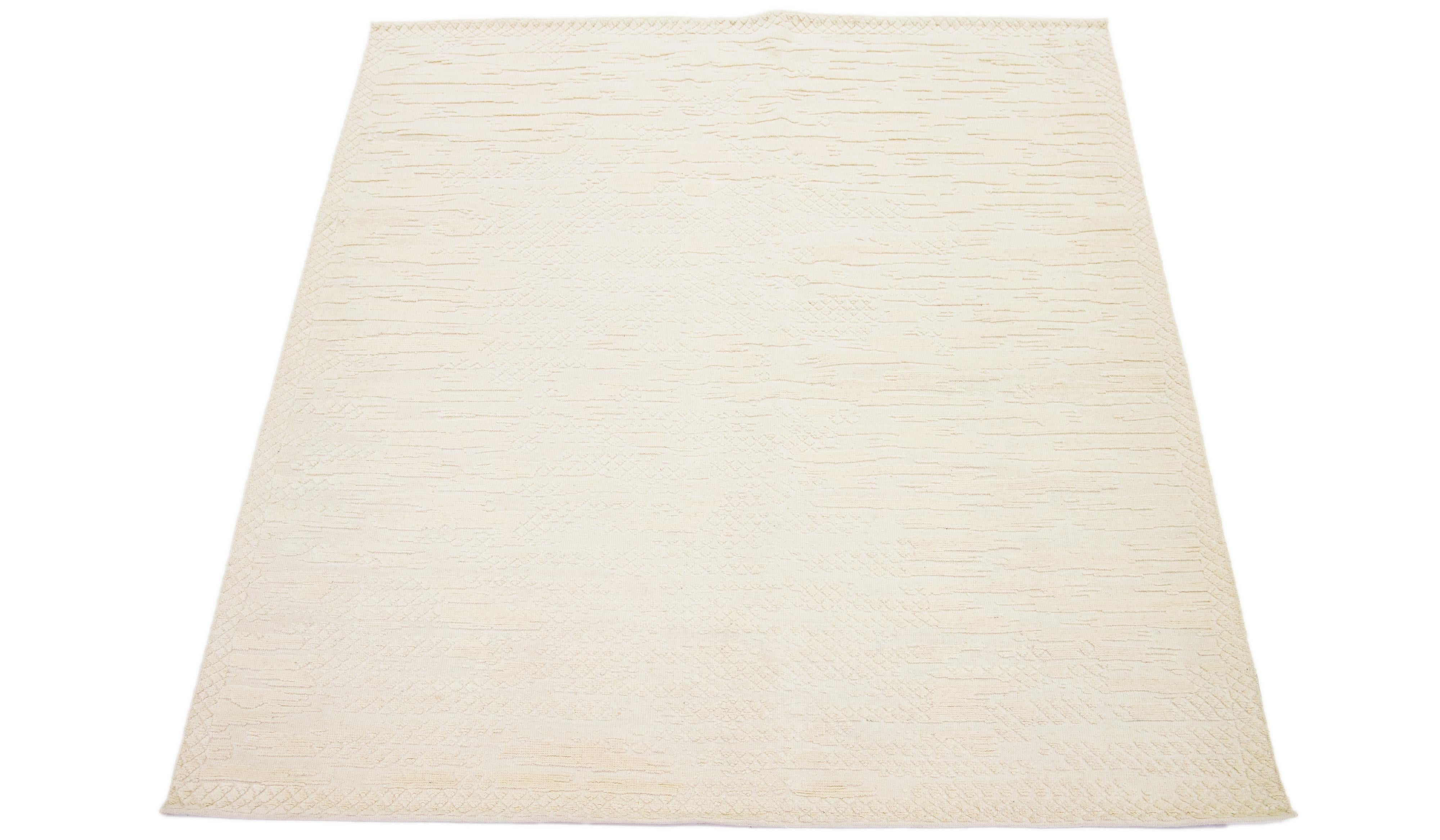 Beautiful modern Moroccan-style hand-knotted wool rug with a natural beige field. This rug is part of our Apadana's Safi Collection and features an abstract design.

This rug measures 7'10