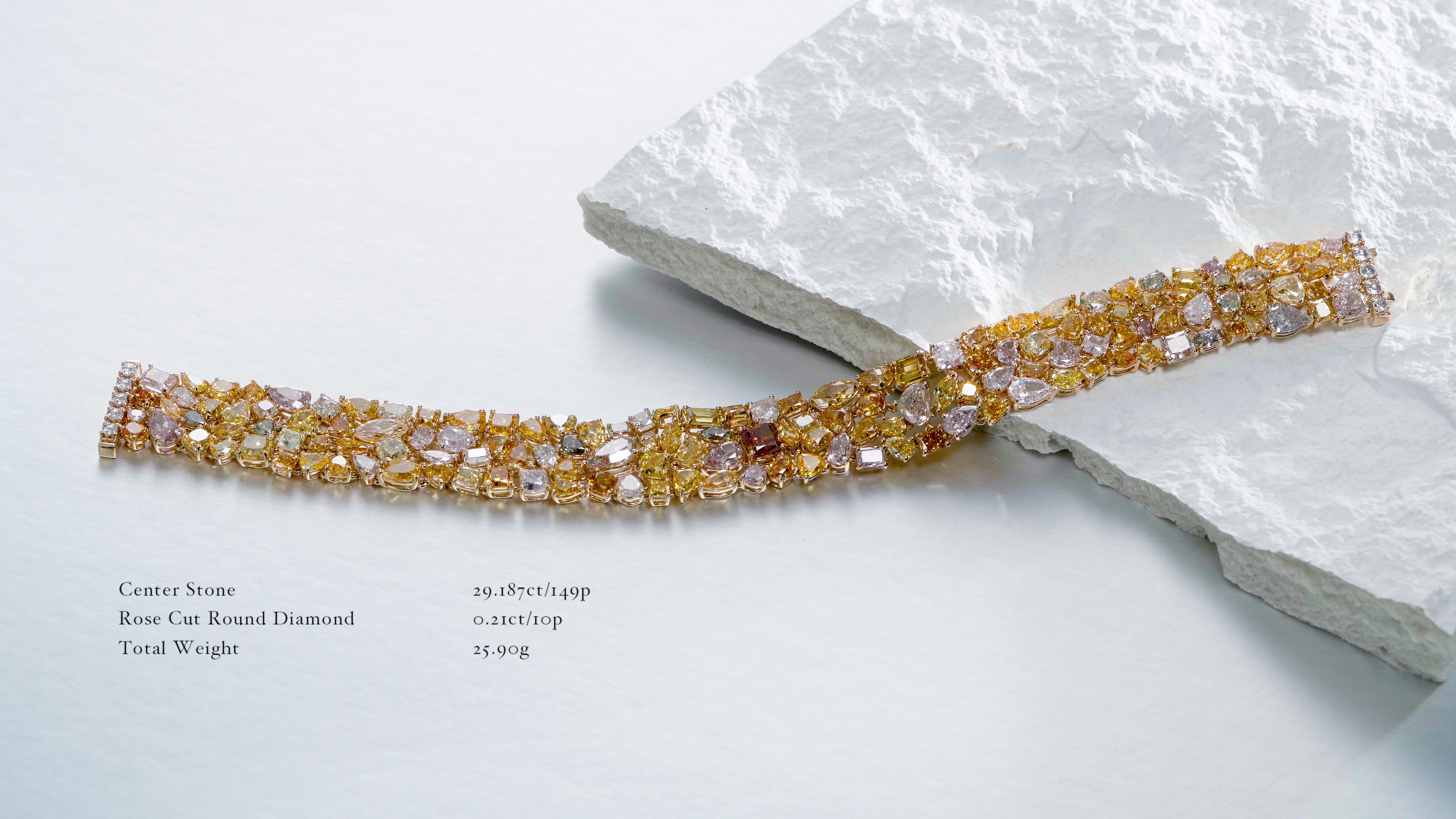 This captivating and unique link diamond bracelet showcases a stunning array of natural fancy colored diamonds set in 18-karat gold. The bracelet is an exquisite blend of various shapes and a spectrum of vivid colors, creating an enchanting and