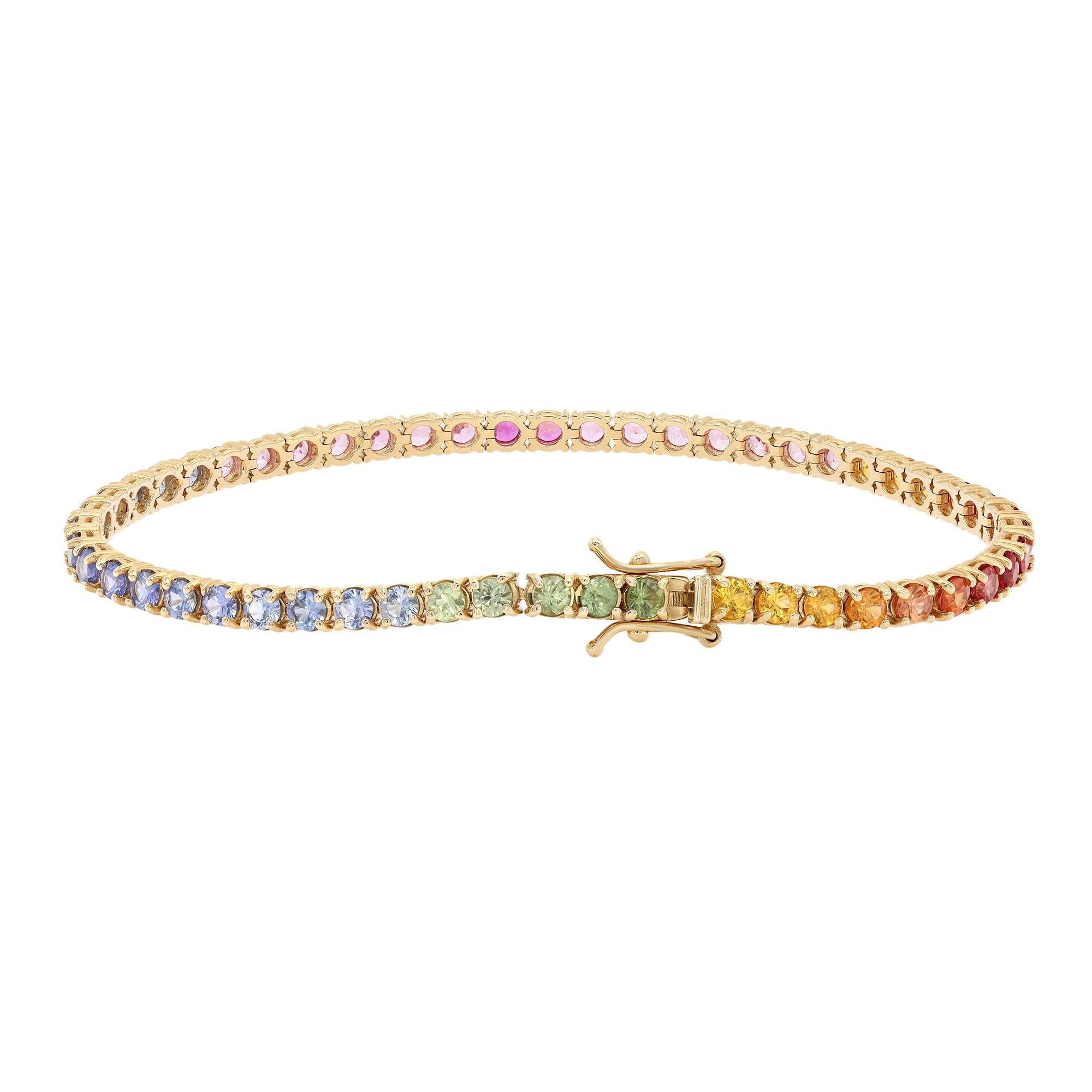 A classic yet vibrant rainbow tennis bracelet blazing with the brilliance of 53 round brilliant cut natural multicolored Sapphires with a total weight of 7 carats. Crafted in sleek 14k yellow gold. Four prong setting. Bracelet length: 7 inches.