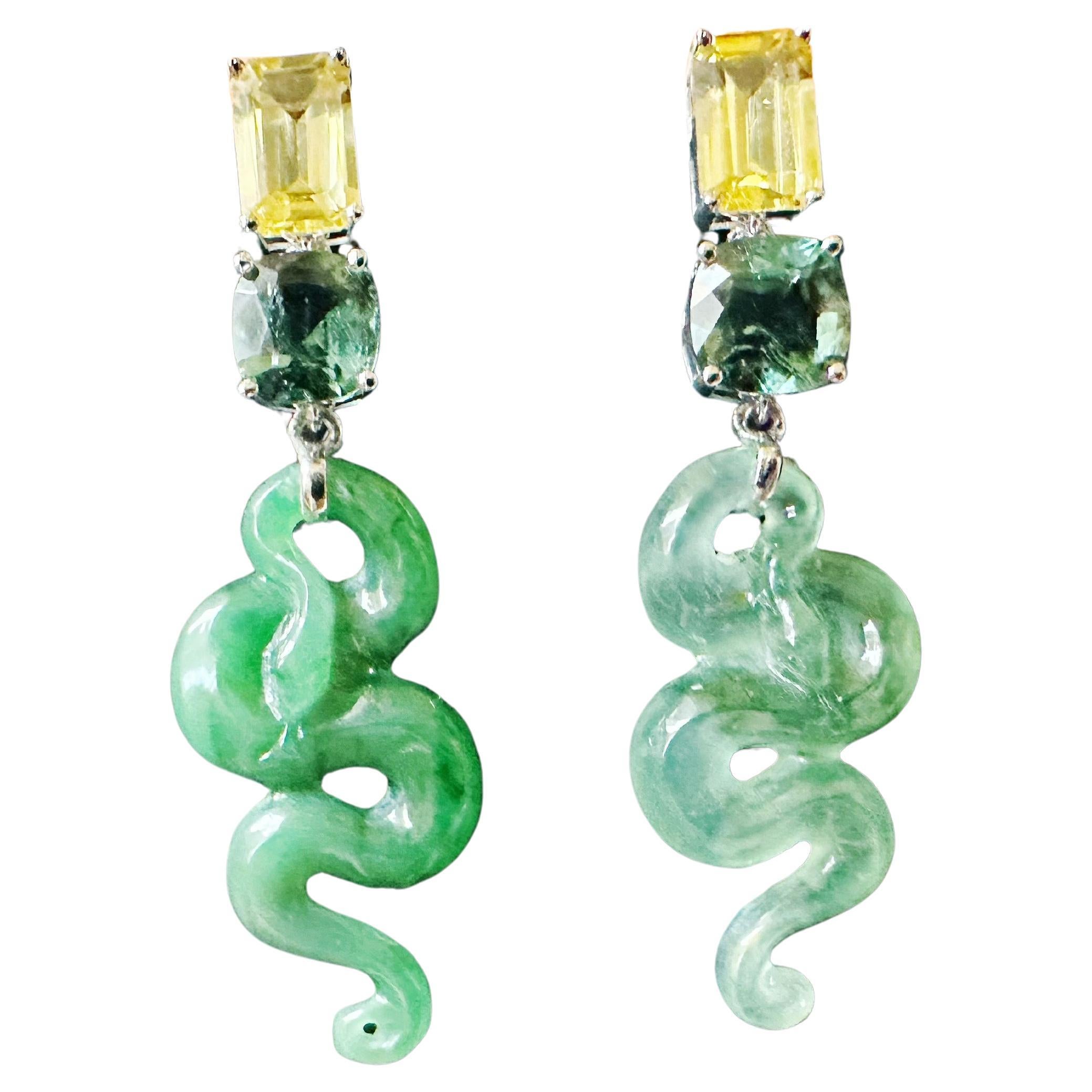 Celebrate the Year of the Snake with our striking asymmetric jade snake earrings, crafted in 18K white gold. Each earring features intricately carved jade, symbolising wisdom and renewal.

Adorned with vibrant yellow sapphires and rich garnet