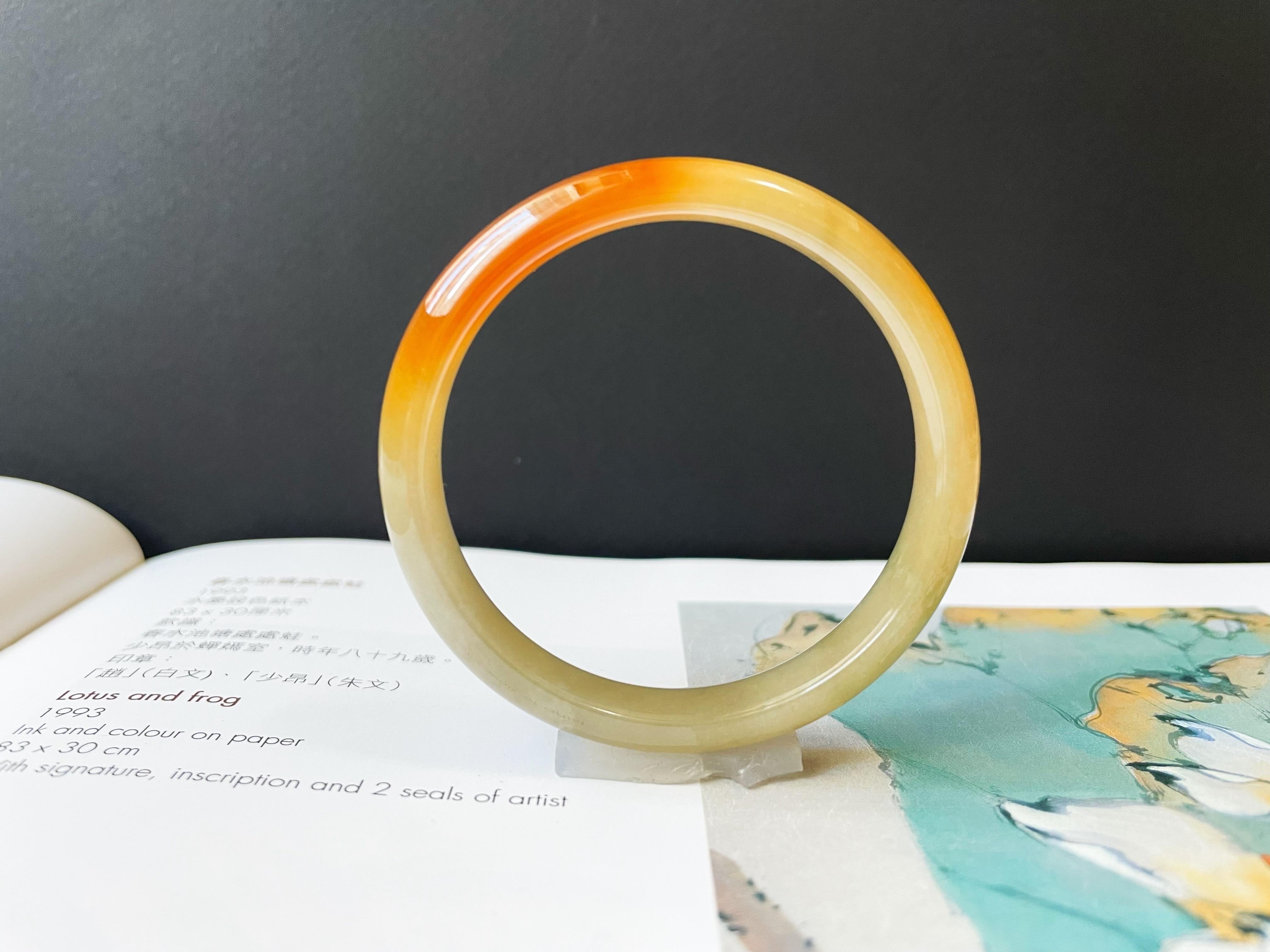 This stunning, premium Myanmar jade bangle is 100% natural, untreated and undyed Grade-A jadeite jade. This bangle is icy, watery with very fine grains, which is nothing short of magnificent. The stunning colors of yellow and red gifted by Mother