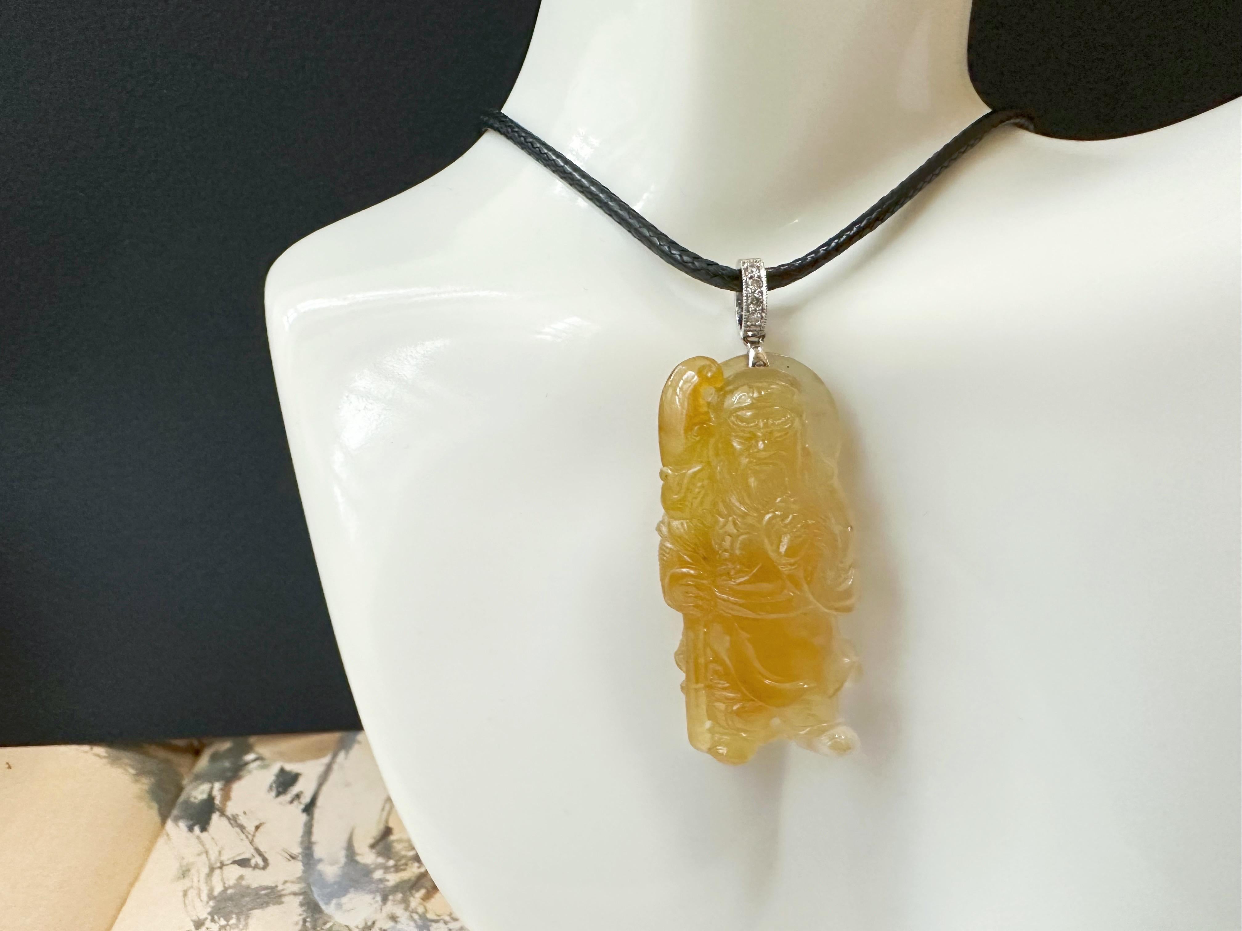 This jade pendant is 100% natural, untreated, and undyed Type-A Myanmar jadeite jade. It is hand-carved into a Guan Gong. The beautiful, fine, icy texture with honey-yellow color gifted by Mother Nature makes this pendant unique and attractive. This