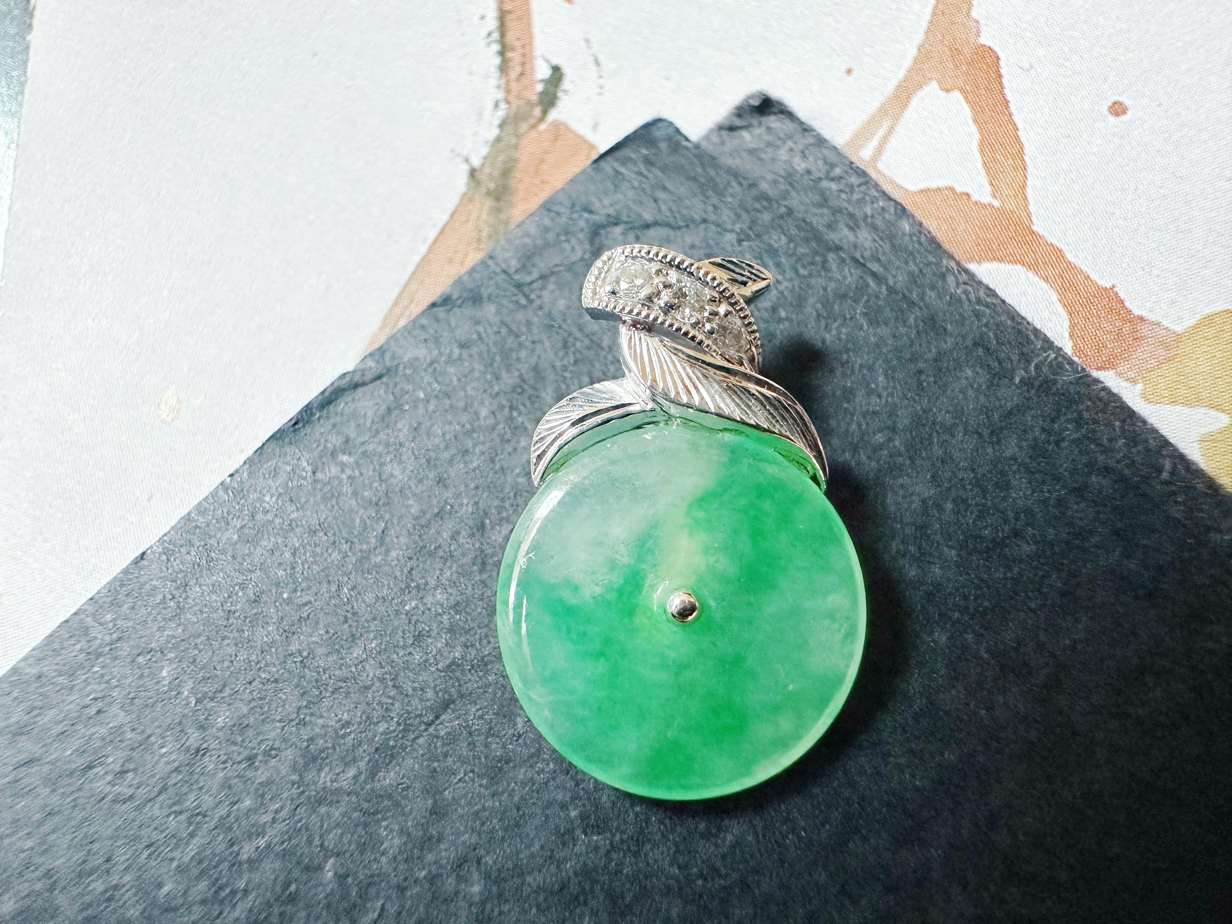 This exquisite pendant is handcrafted from natural green jade from Myanmar, featuring an intensely vivid color that resembles a tiny green light bulb. The rich hue and unique craftsmanship make this piece a standout addition to any jewelry
