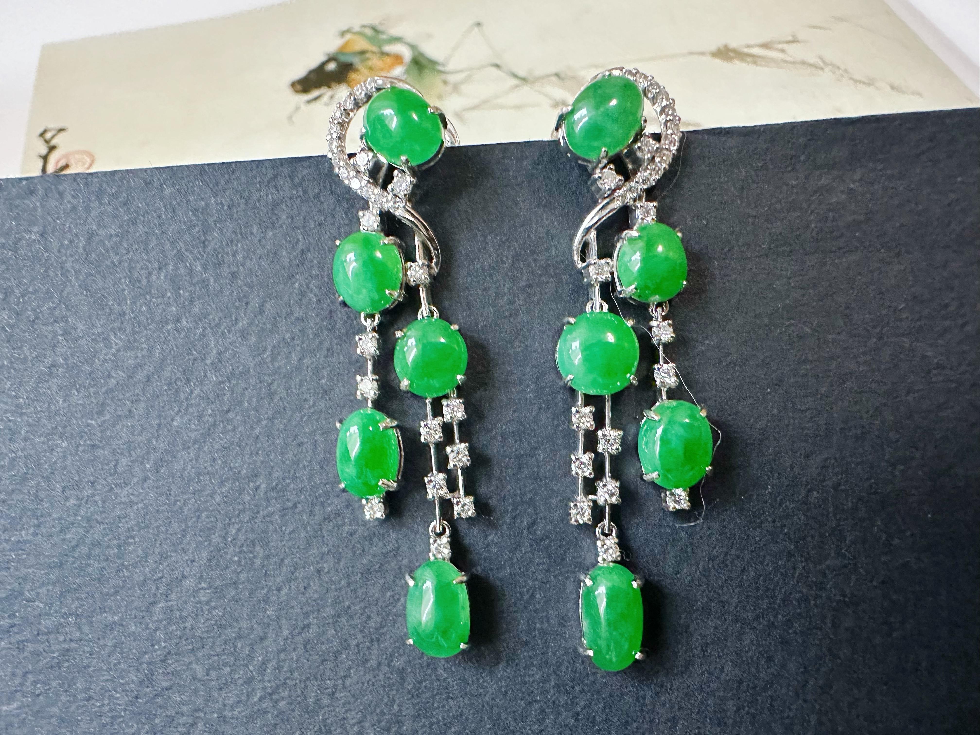 These exquisite drop earrings are handcrafted with ten stunning imperial green jade cabochons, beautifully accented by sparkling diamonds. The elegant design showcases a graceful dangling style, making it a perfect statement piece for any