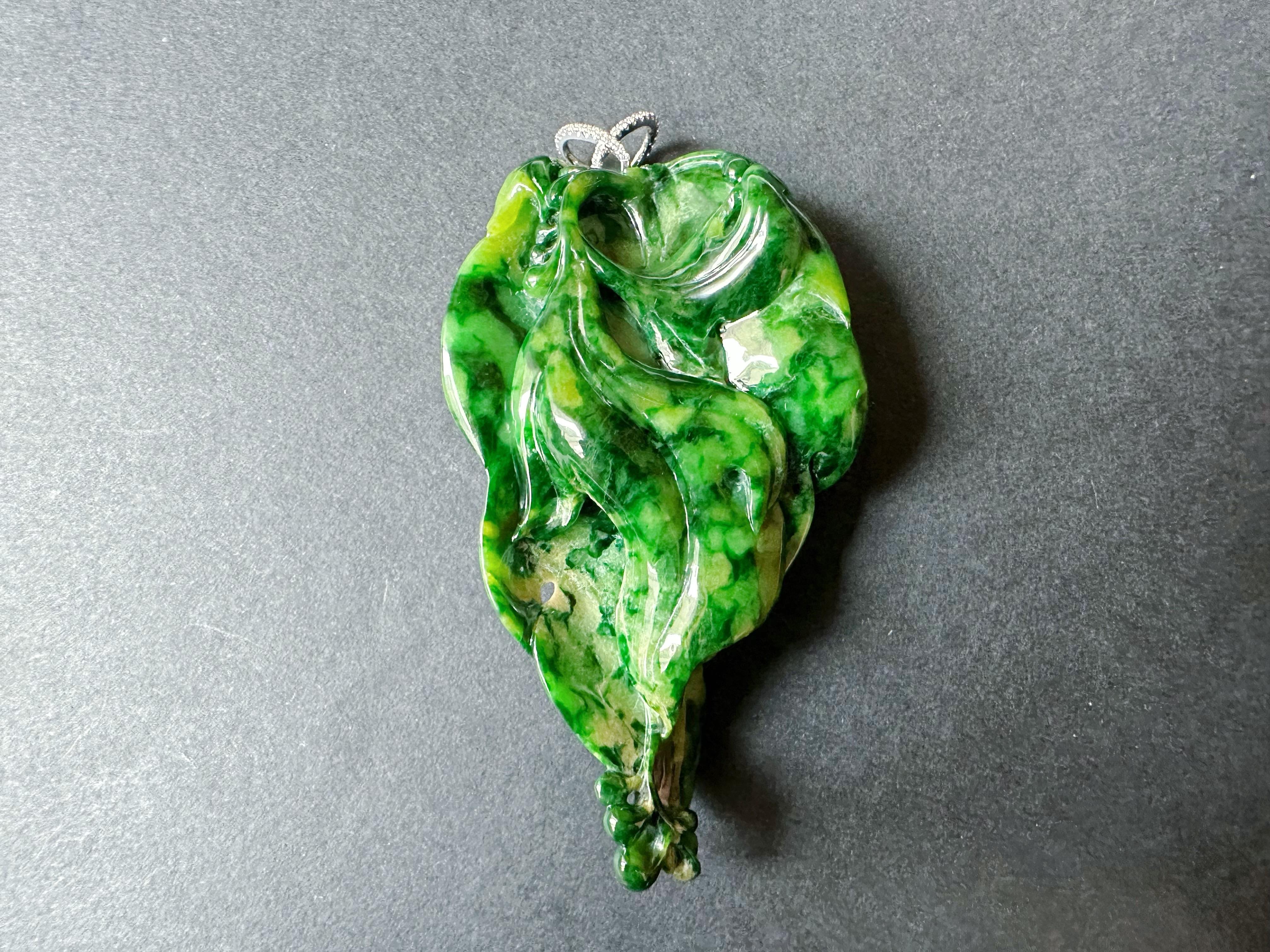 Discover the breathtaking beauty of this one-of-a-kind jade pendant, crafted with the finest materials and meticulous attention to detail. Featuring a stunning imperial green jade lotus leaf, this pendant is a true masterpiece of nature and