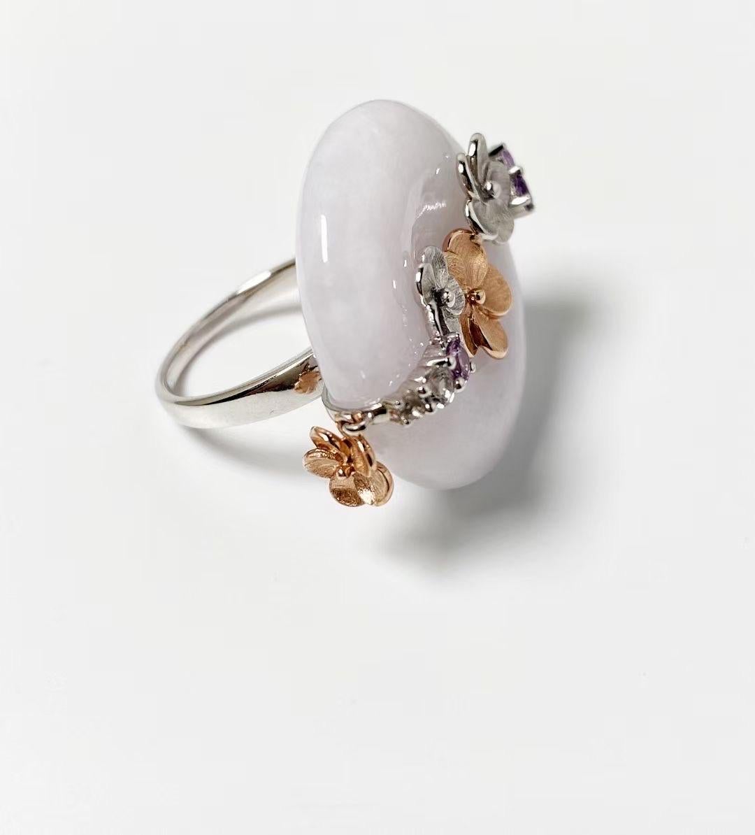 Introducing the Cherry Blossom Lavender Jadeite Donut Ring, as intricate and precious as nature. Each one-of-a-kind Type A Jadeite ring is framed with luxurious 14kt solid rose gold and white gold petals and embellished with splendid colored