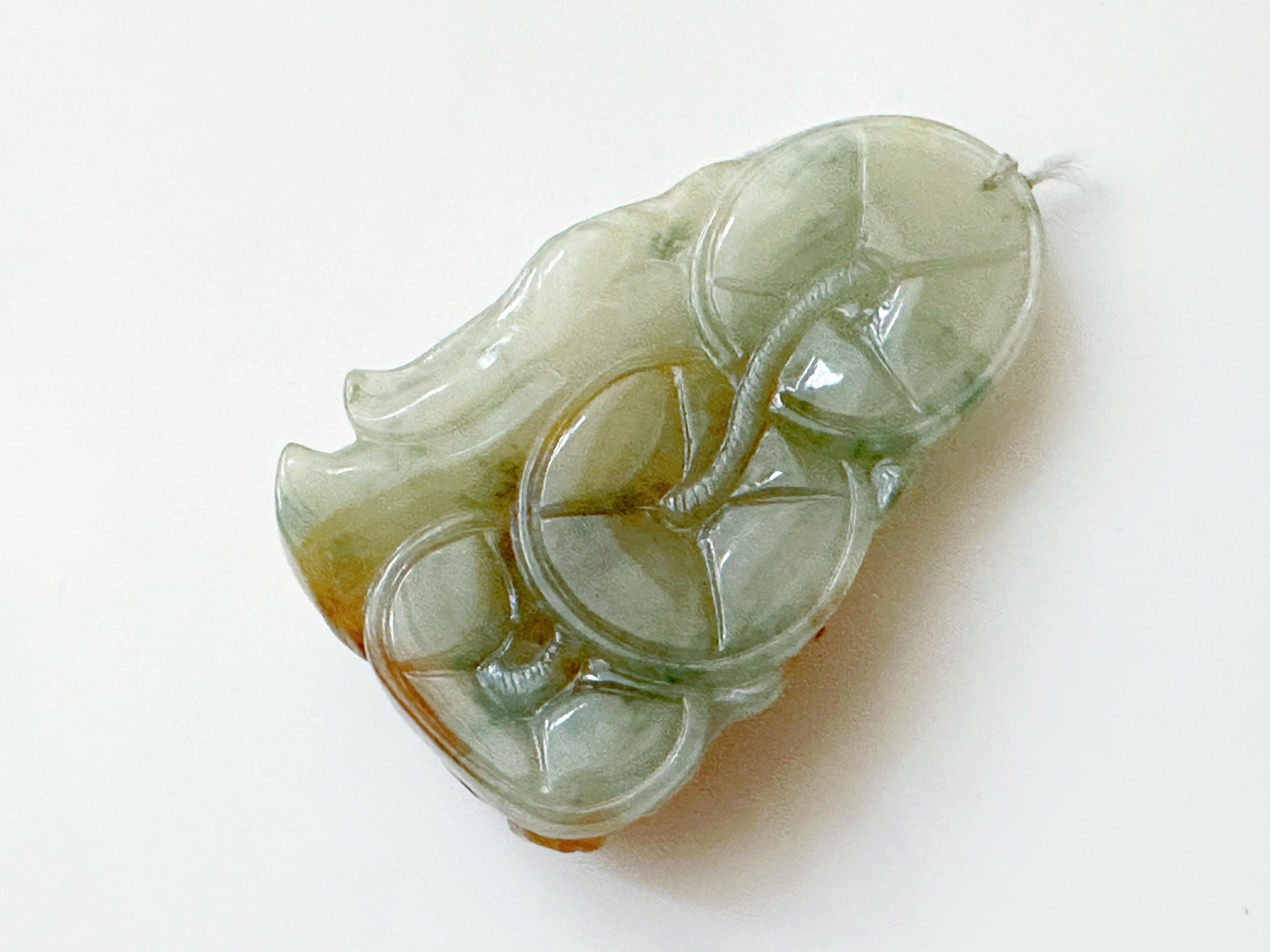 This jade pendant is 100% natural, untreated, and undyed Type A Myanmar jadeite. It is hand-carved into Liu Haichan. Beautiful translucent icy texture with tricolor green, yellow, and red patches gifted by Mother Nature makes this pendant unique and