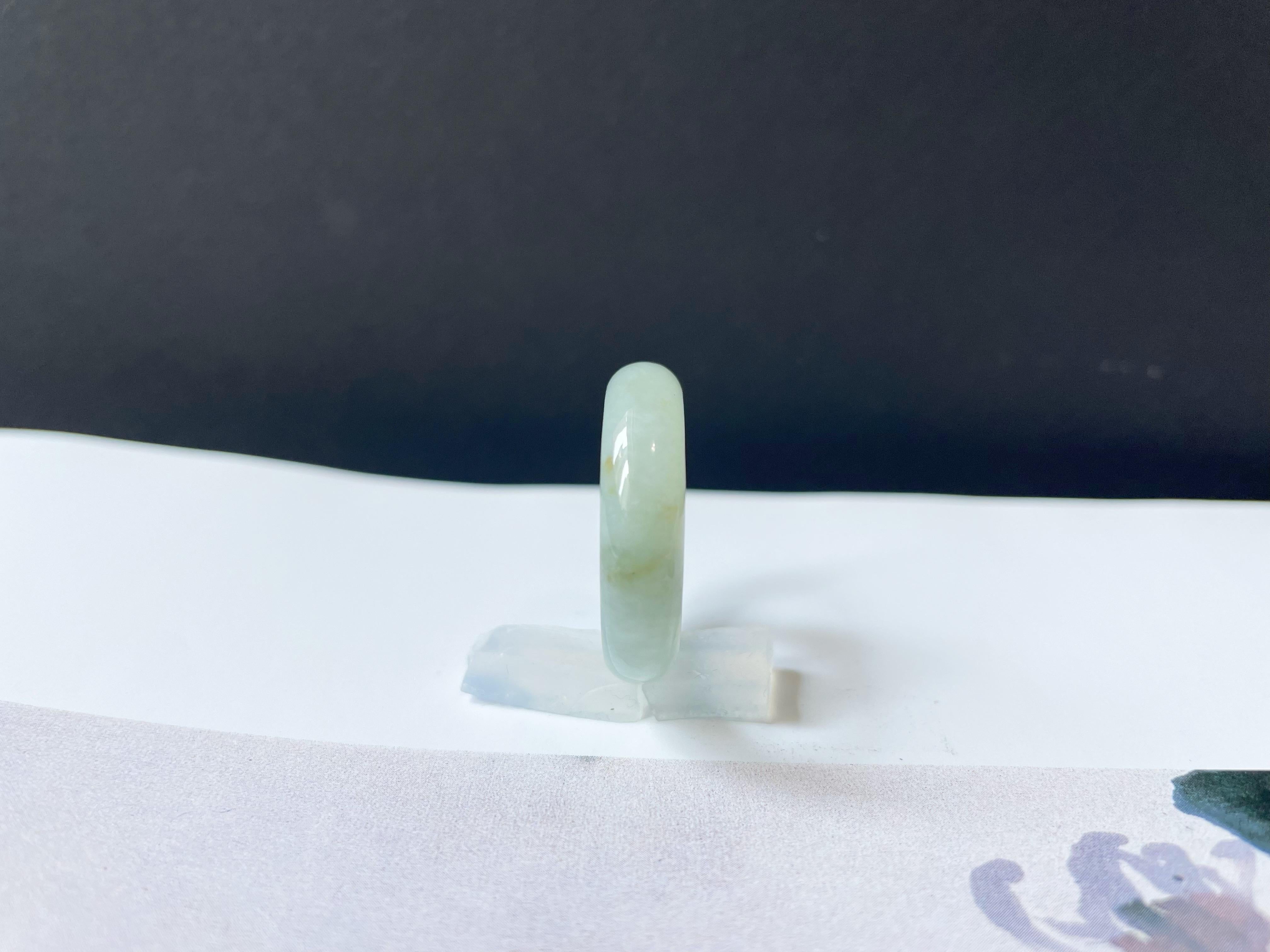 Discover the allure of our A-Grade Natural Myanmar Jadeite Ring Band, meticulously handcrafted from 100% natural, untreated, and undyed Type A jadeite. This exquisite ring showcases a unique pale green color with beautiful yellow patches, making