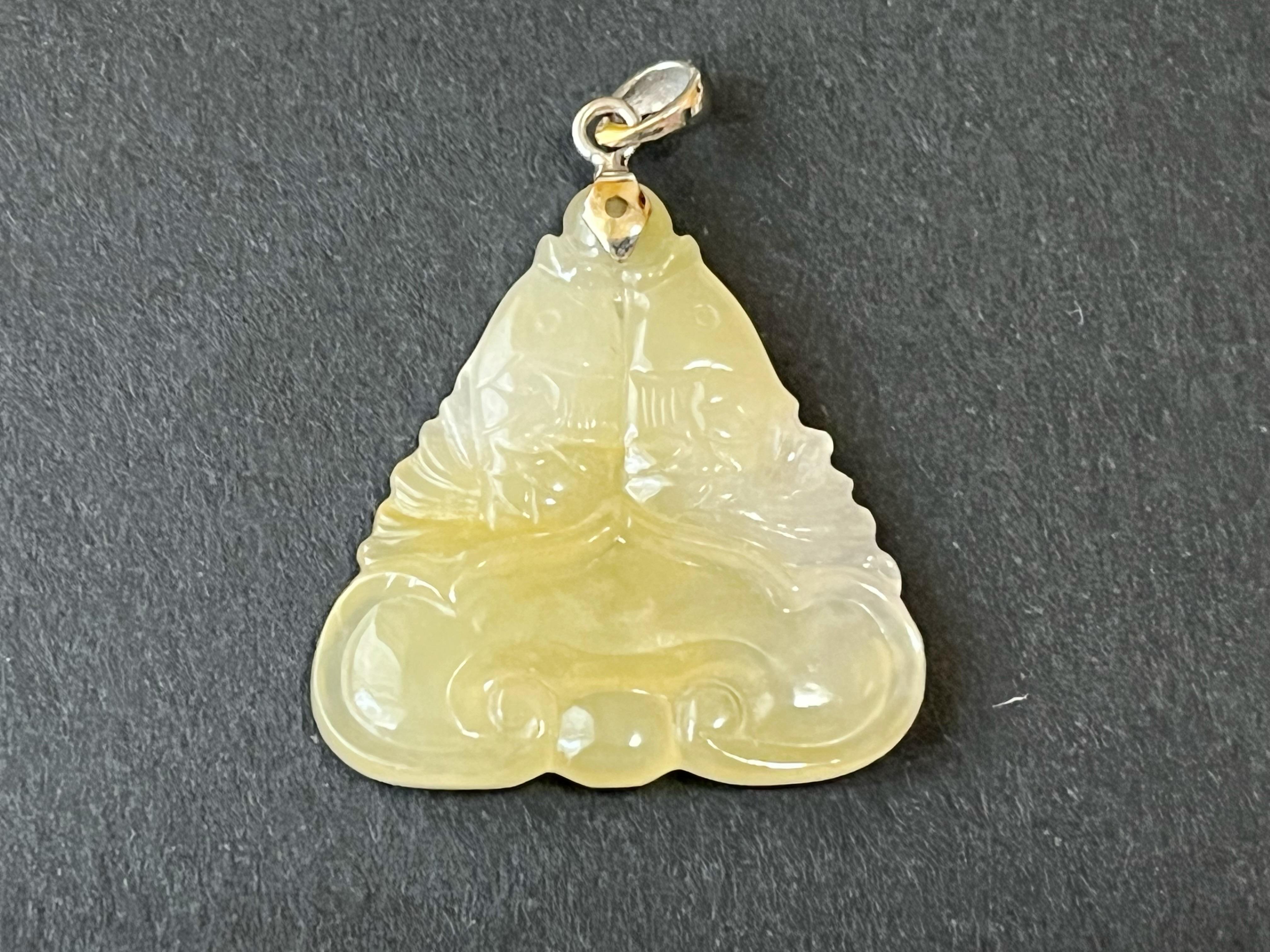 Introducing a stunning high-quality translucent icy jade Pisces pendant that is sure to captivate your heart. This exquisite piece features a beautifully carved Pisces fish motif.  Crafted from the finest quality translucent icy jade, this pendant