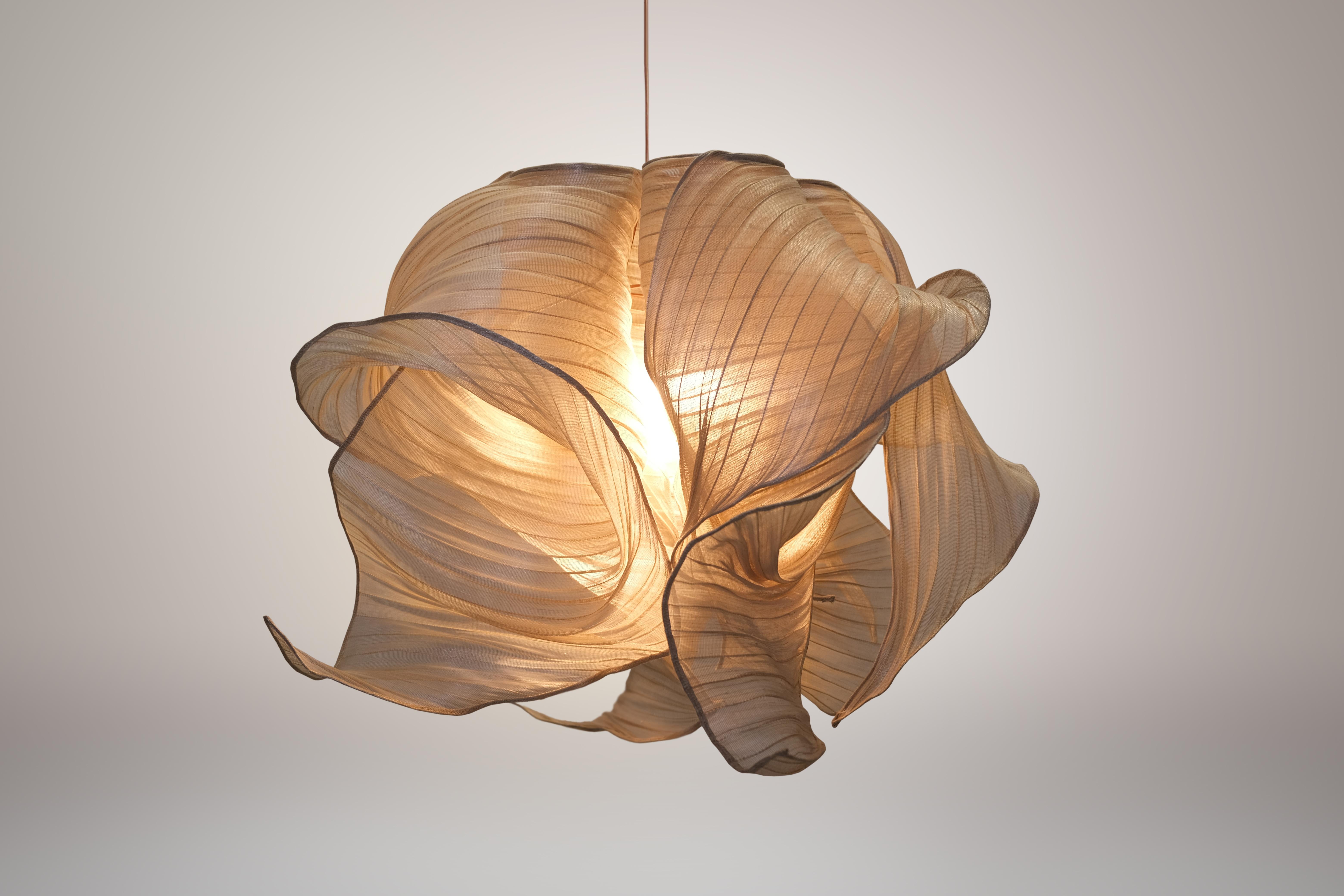 Natural Nebula pendant lamp by Mirei Monticelli
Dimensions: D 60 x W 60 x H 60 cm
Materials: Banaca fabric
Available in other colors.

Providing soft light in an organic and unique design, the Nebula Lamp draws its inspiration from the