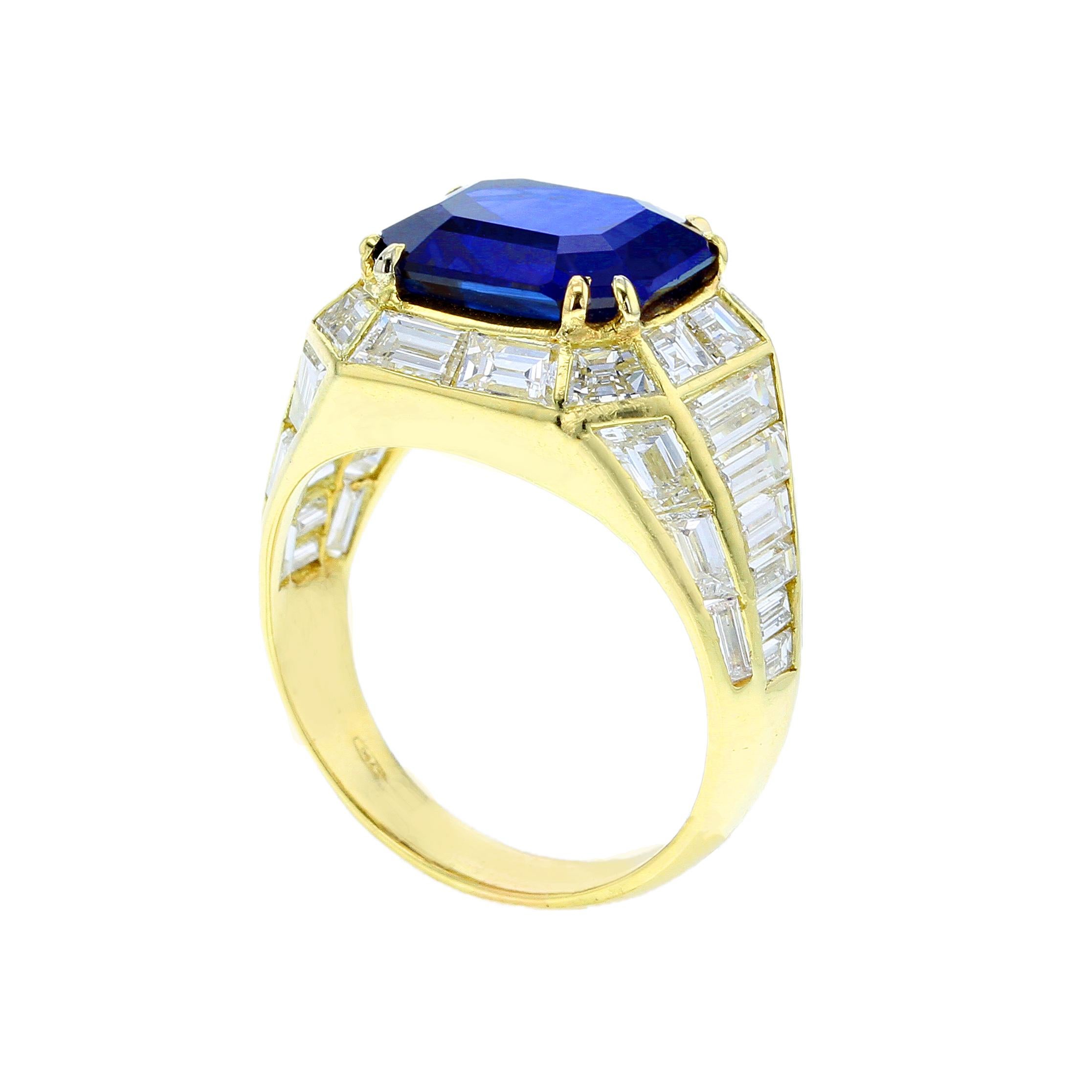 A chic sapphire and diamond ring, centered with an approximately five carat, natural no-heat rectangular step-cut Burma Sapphire, accented with a single row of tapered baguettes, flowing towards the shoulders and tapered sides; stamped 750. The