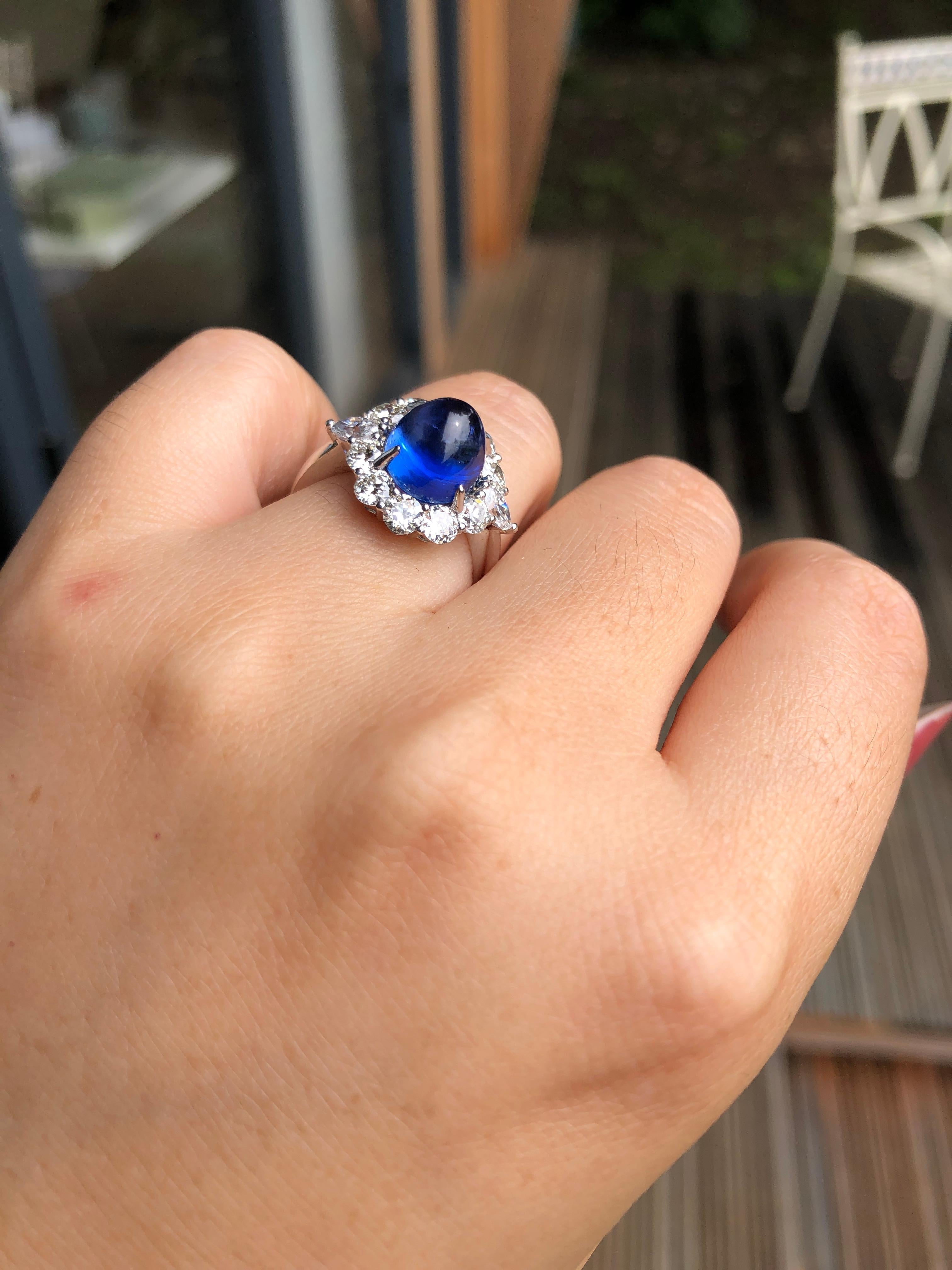 Sapphire: 6.35ct
Total Diamonds: 1.6ct
Size: UK size N, US size 6 1/2
Weight：5.33g

An arresting cabochon sapphire  and diamond ring. When a sapphire is cut as a cabochon it gains a mysterious quality, as though you are looking out into space or the
