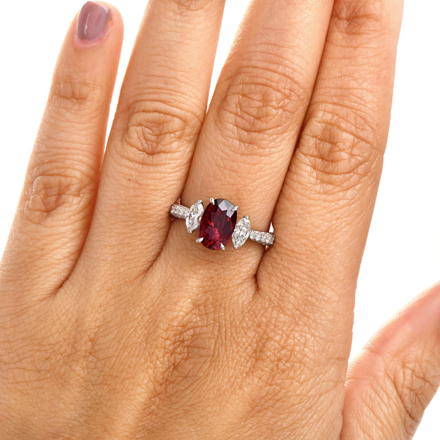 A classic three-stone ring centered with a vivid 