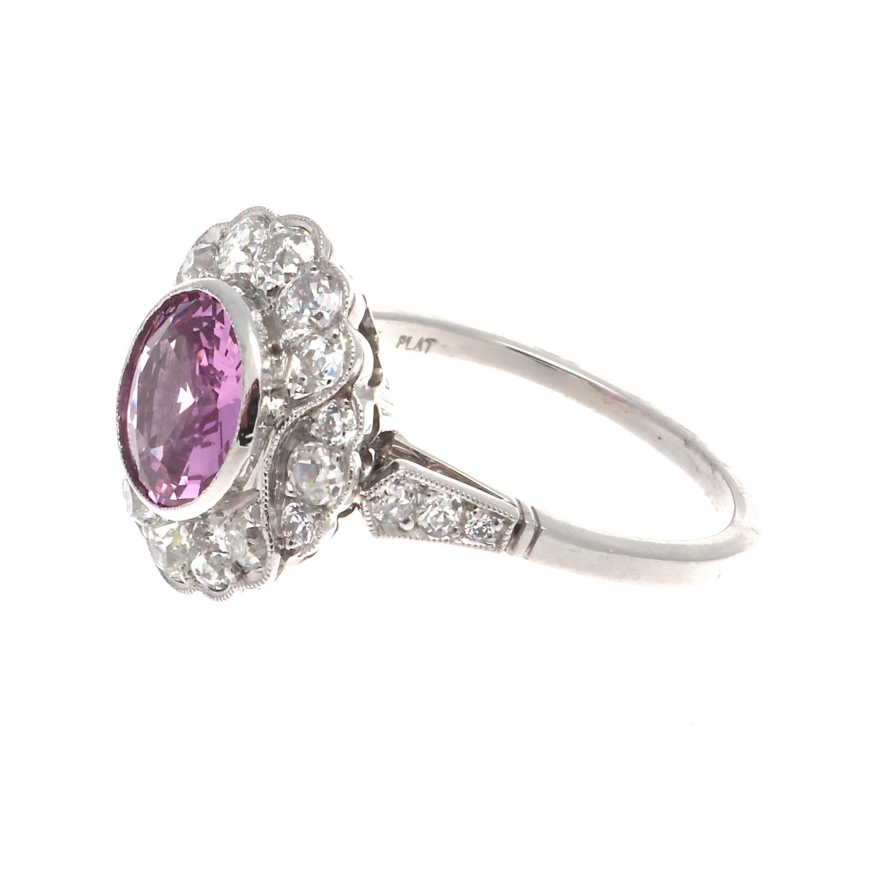 A traditional idea synthesized with a symphony of color. The perfect way to remember old times and good times to come, with your loved one. Featuring a 1.92 carat no heat pink sapphire that is perfectly surrounded by a floating halo on near
