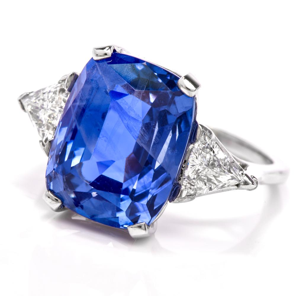 This beautiful blue sapphire and diamond three stone ring is crafted in solid platinum. Featuring a prominent cushion Ceylon natural sapphire without any heat or other treatments. all natural, approx. 12.60 carats. Alongside are two triangular cut