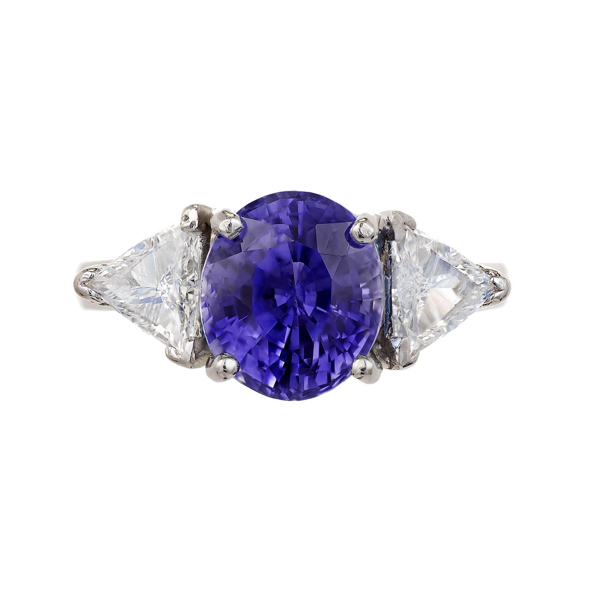 Bright purple blue natural no heat 5.17ct oval Sapphire diamond Platinum three-stone engagement ring. Matched with very sparkly trilliant cut side diamonds in a platinum setting.

1 purplish blue oval shape Sapphire, approx. total weight 5.17ct, AGL