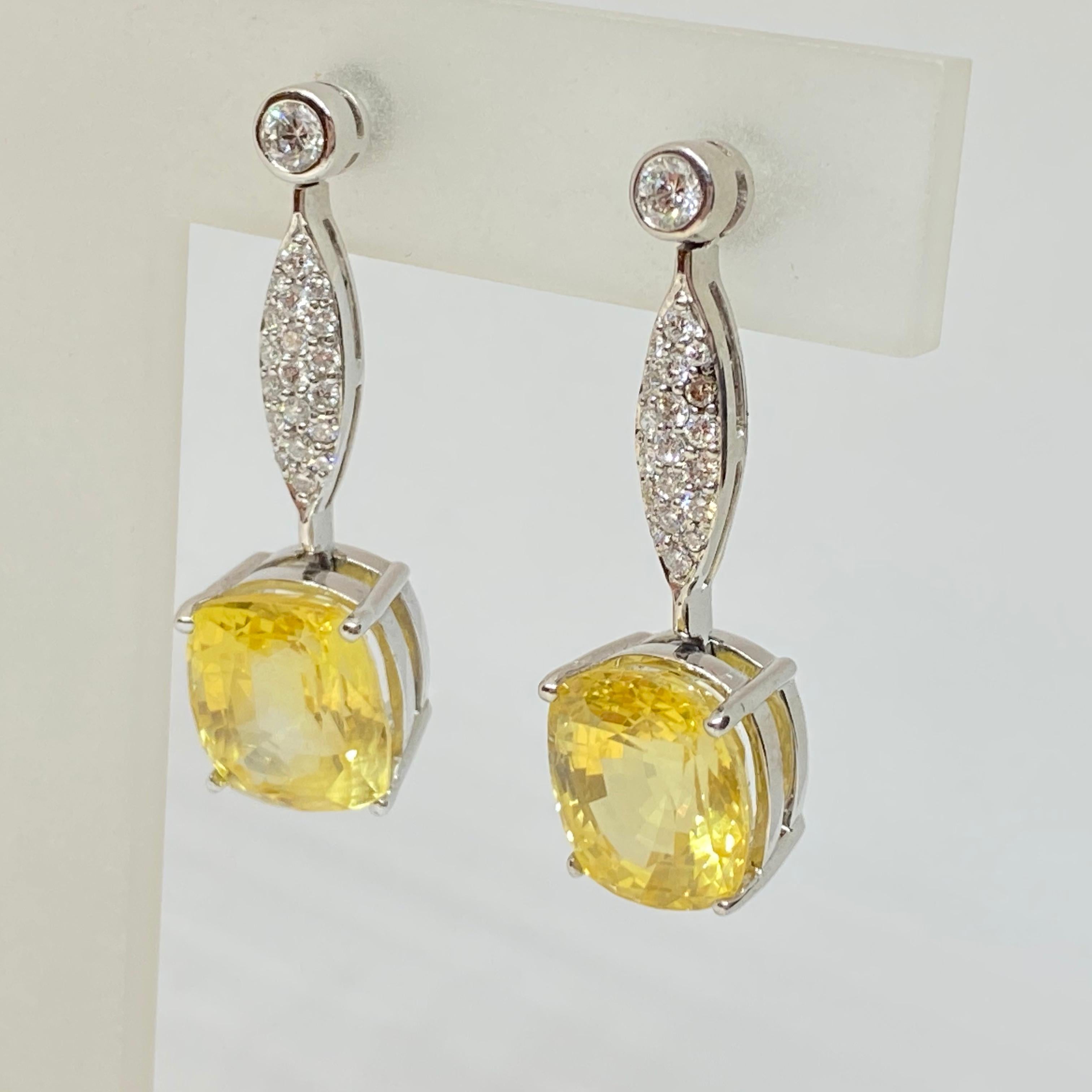 Natural NO HEAT Yellow Sapphire Oval Dangle Drop Diamond Earrings 18KW 16.60CTW
Lovely estate dangle drop earrings designed in 18 karat white gold. NO HEAT, untreated light canary natural yellow sapphires suspended from a pave & bezel diamond drop