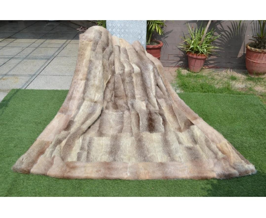 This is a beautiful and luxurious natural nutria beaver king size blanket.
Soft pelts with rich, earthy coloration,  accented with black backing.
This is perfect for a bed or just for sitting under on the couch.  
These make wonderful gifts and with