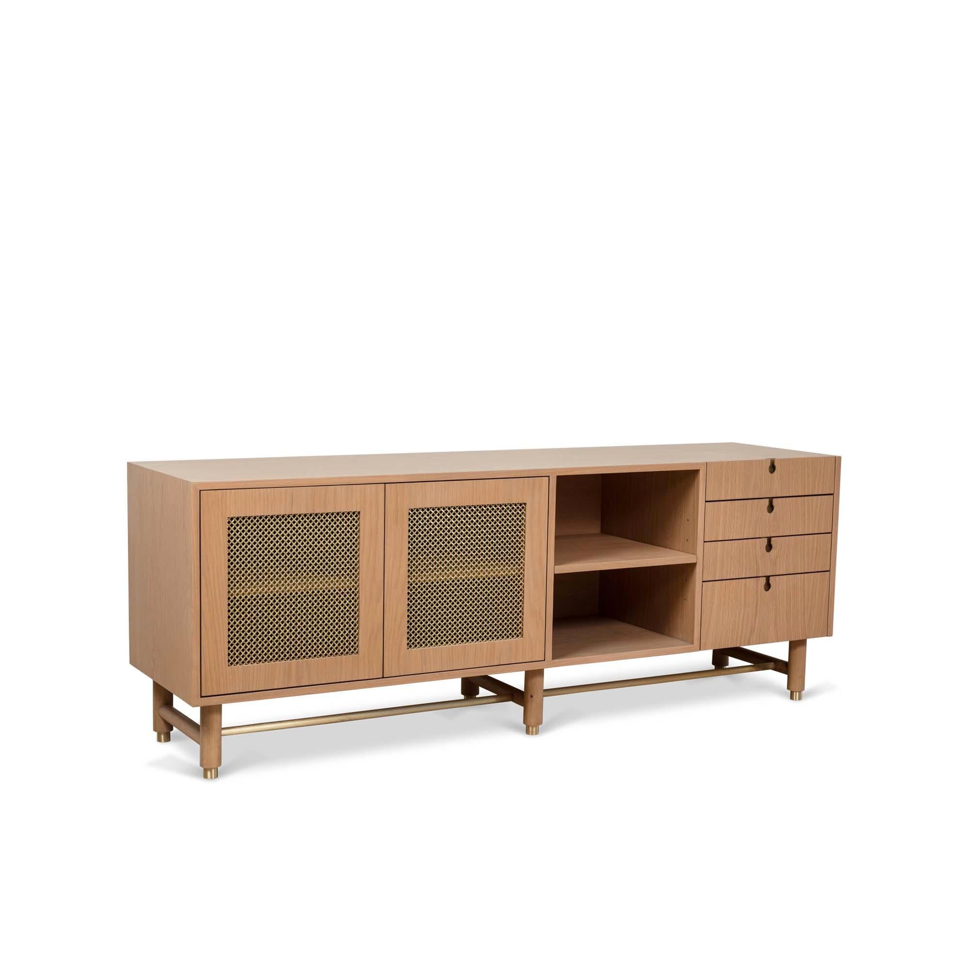 The Niguel Credenza features brass cap feet, a brass cross-stretcher bar and brass inlaid details with brass mesh sliding bypass doors. 

The Lawson-Fenning Collection is designed and handmade in Los Angeles, California. Reach out to discover what