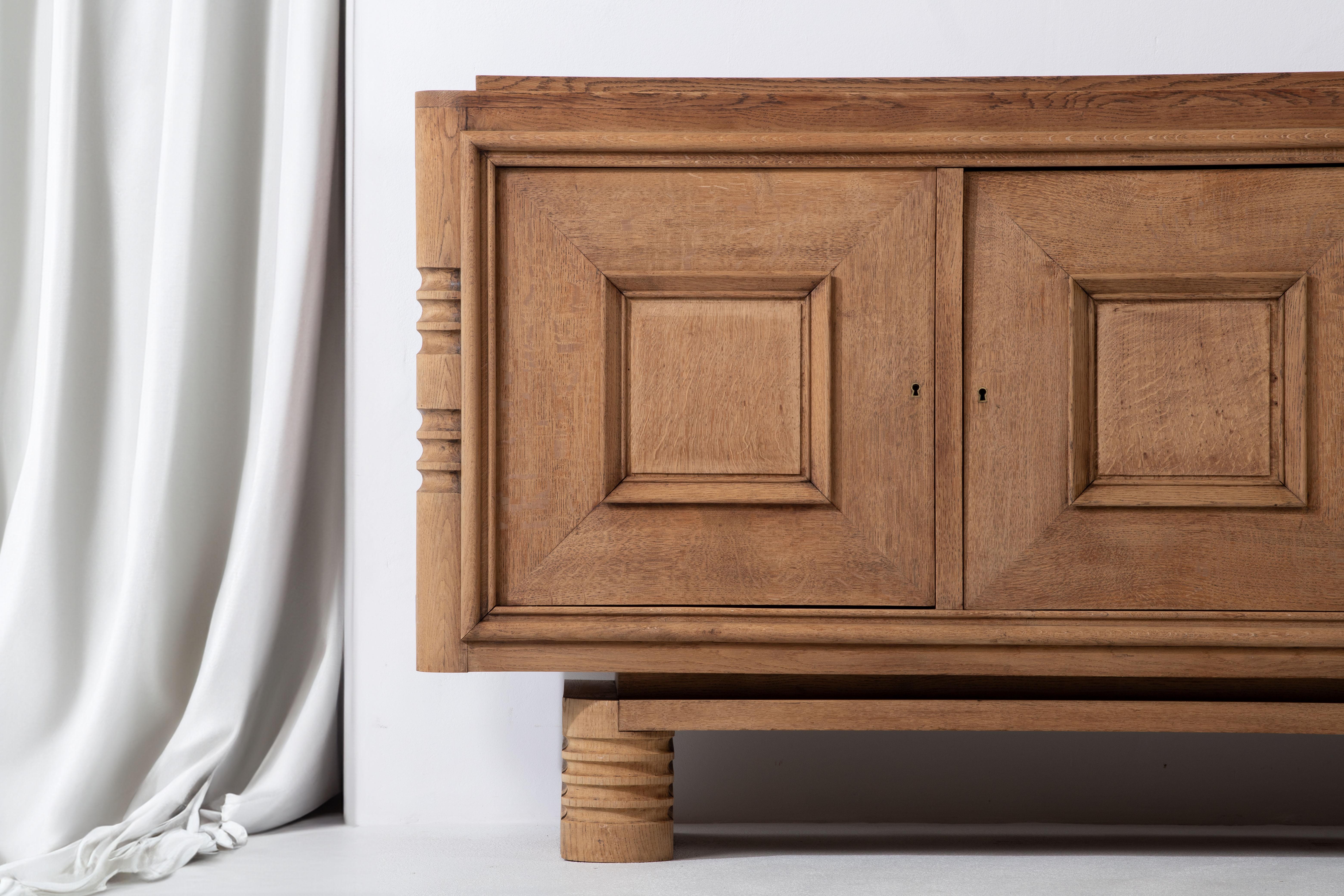 Introducing an exquisite Art Deco buffet in natural oak, crafted in the style of the renowned French furniture designer, Charles Dudouyt. Dudouyt's work is celebrated for its exceptional craftsmanship, innovative designs, and seamless blend of