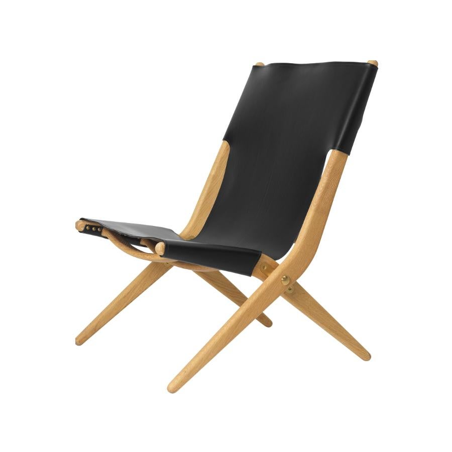 Natural oiled oak and black leather saxe chair by Lassen
Dimensions: W 60 x D 67 x H 84 cm 
Materials: Leather, oak.

Mogens Lassen was perceived as ‘the naughty boy in class’, but he aimed for perfection in each design project. His eye for