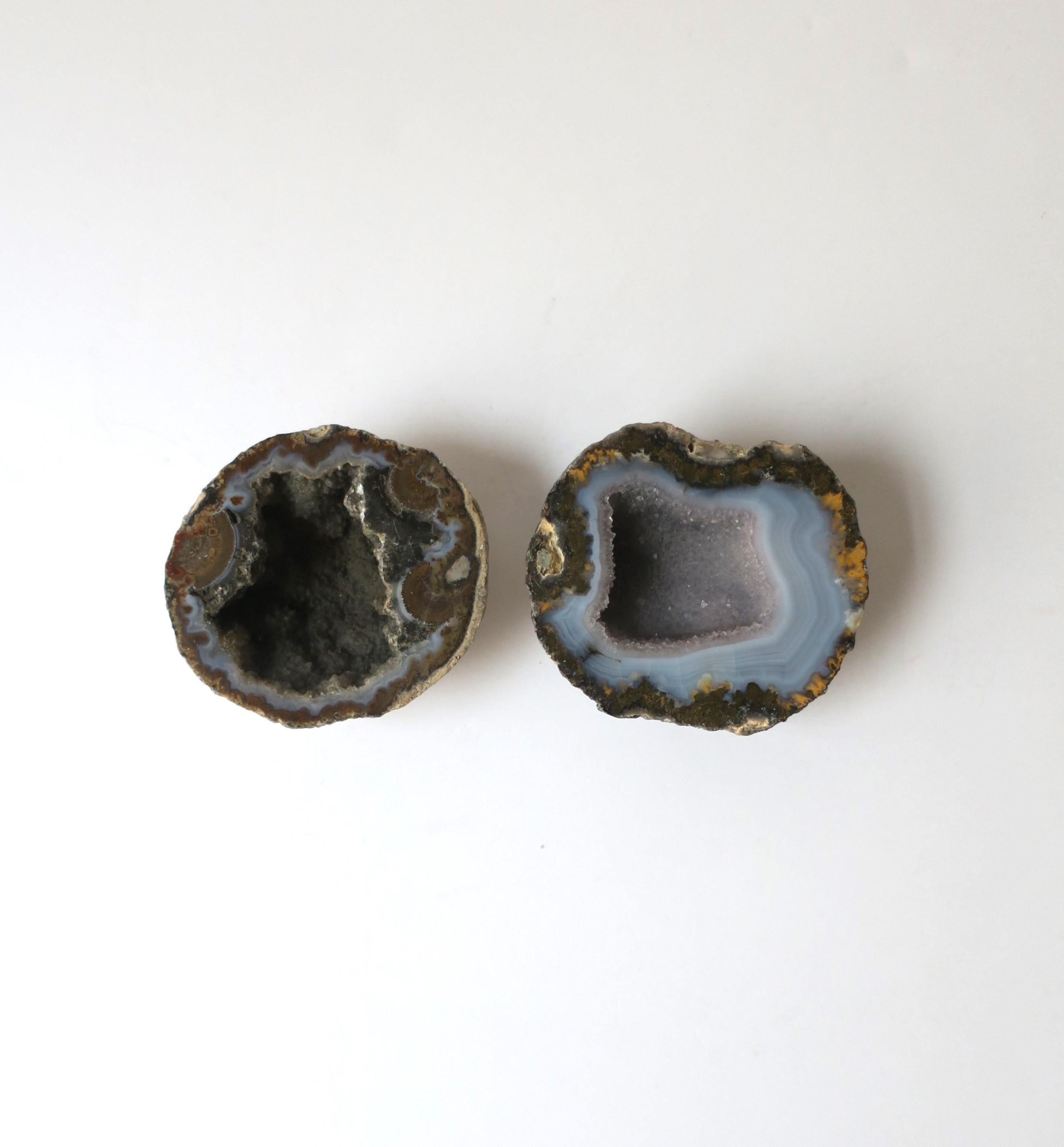 A beautiful, natural set of two (2) onyx agate geode objects. Colors include light blue, grey, and browns.

Dimensions: 
3