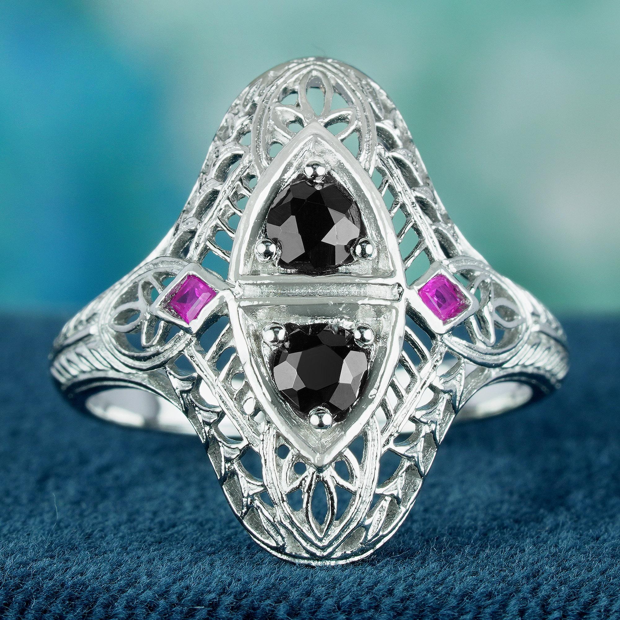 This exquisite ring showcases a vintage Art Deco design, featuring two round natural onyx gemstones gracefully cascading at its centerpiece in a bead setting. Flanking these onyx stones are smaller pink ruby gemstones, each carefully placed on the