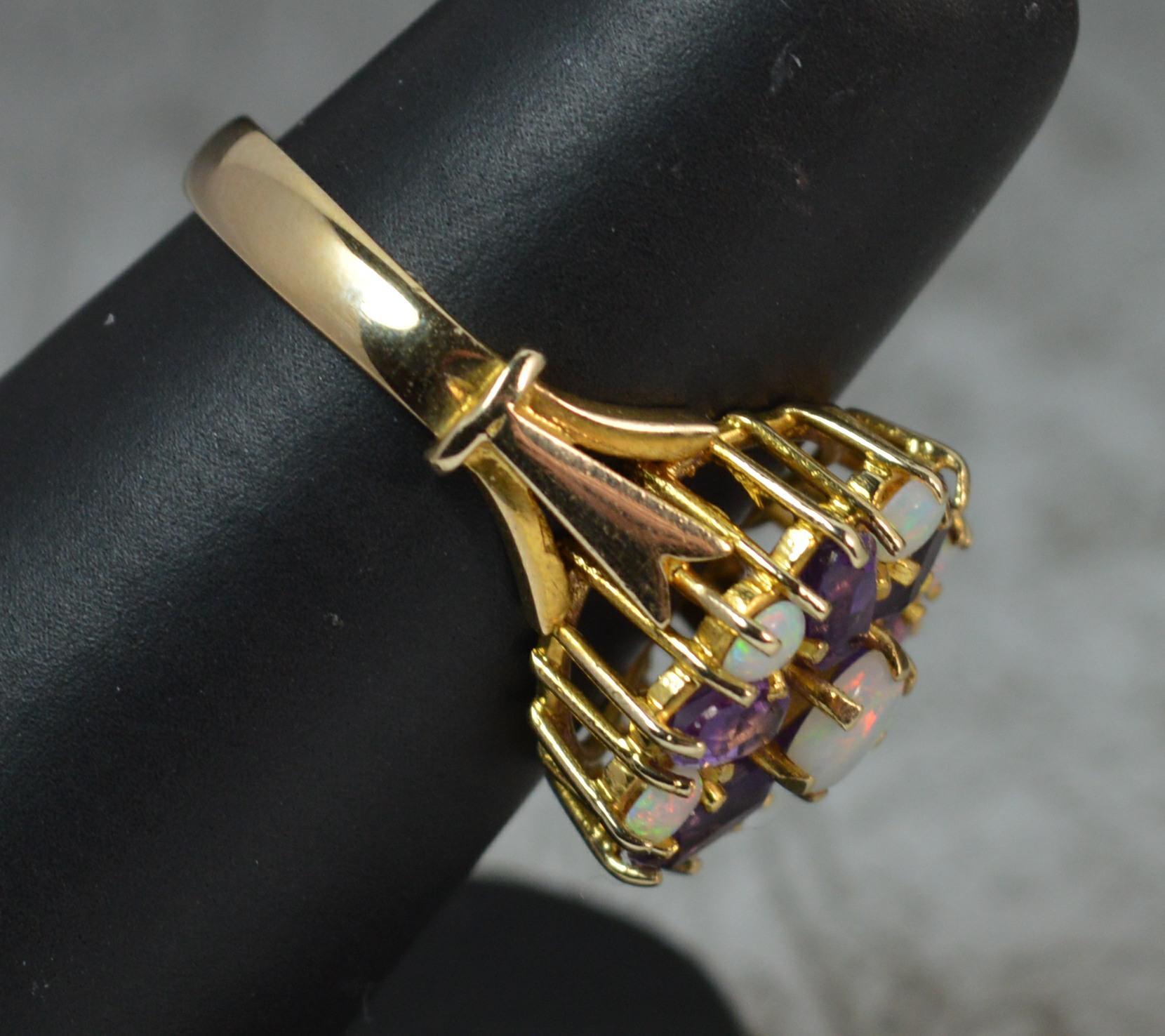 A stunning cluster or cocktail ring.
Modelled with a round opal to centre, six oval amethysts surrounding and six smaller opals surrounding.
Solid 9 carat yellow gold example.
Total cluster to measure 15mm x 15mm head. 7mm off the head.
Condition ;