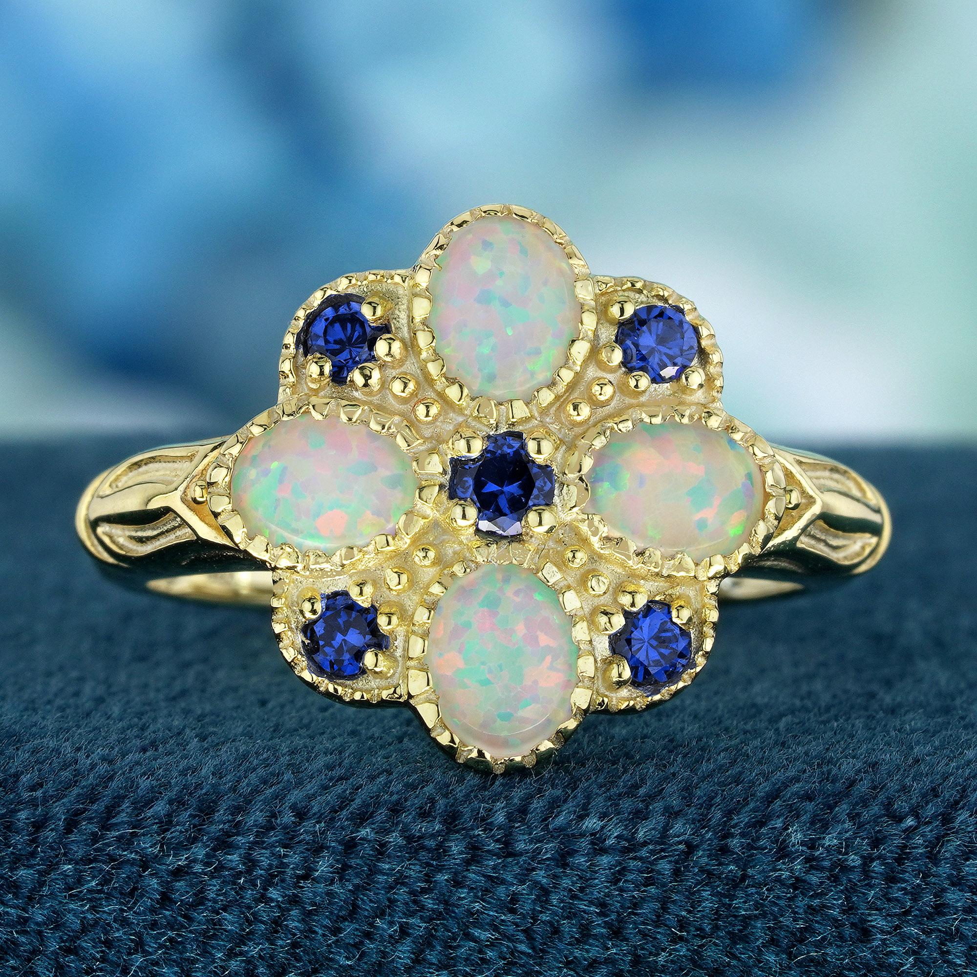 Introducing the vintage-inspired Floral Cluster ring, where iridescent white oval-cut opals form a stunning floral arrangement, showcasing their mesmerizing play of color. Accentuating this floral cluster are natural round blue sapphires, adding a