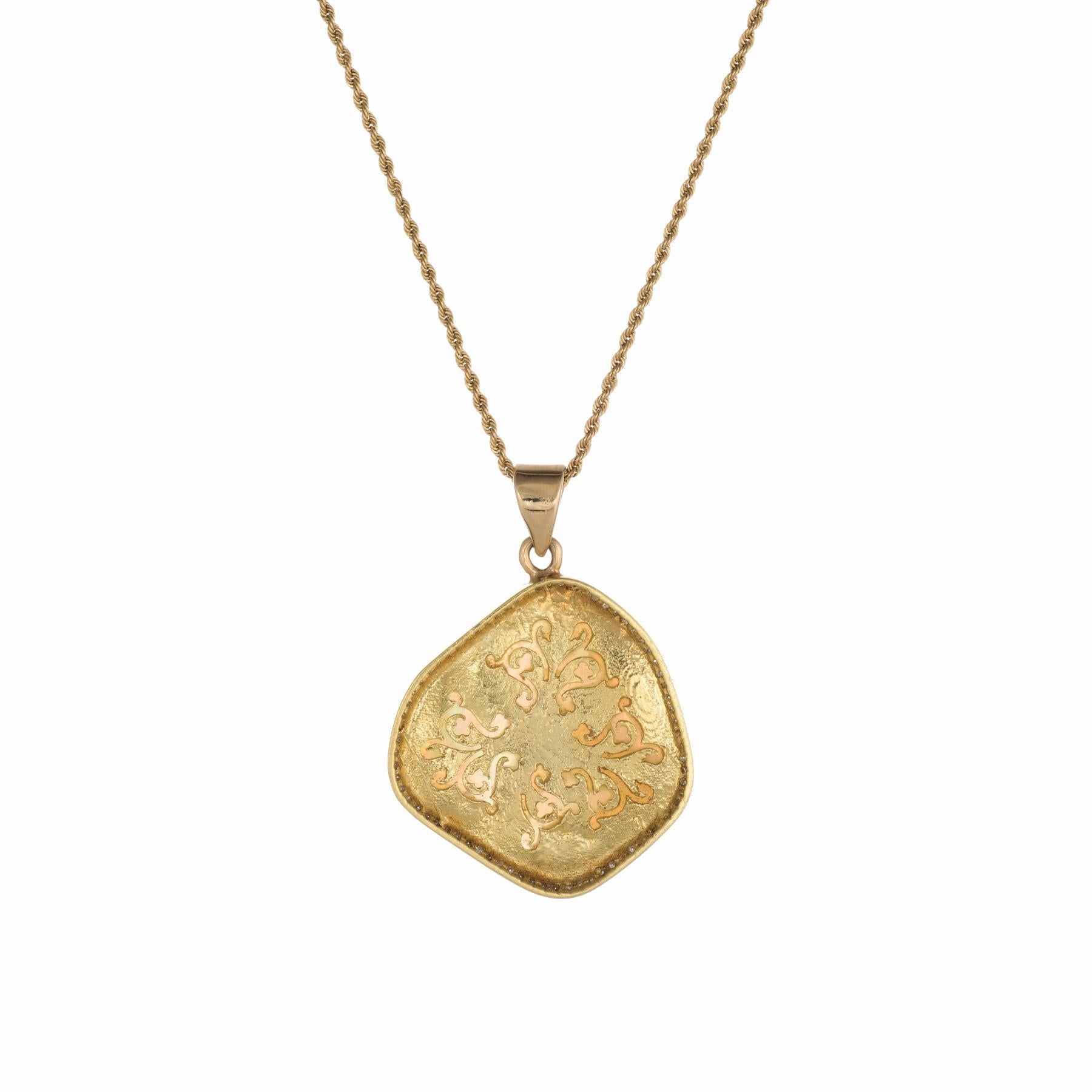 Stylish opal & diamond pendant, crafted in 18 karat yellow gold (pendant) and 14 karat yellow gold (chain).  

A large natural freeform opal measures 26mm x 24mm and is framed with 75 round brilliant cut diamonds that total an estimated 0.37 carats