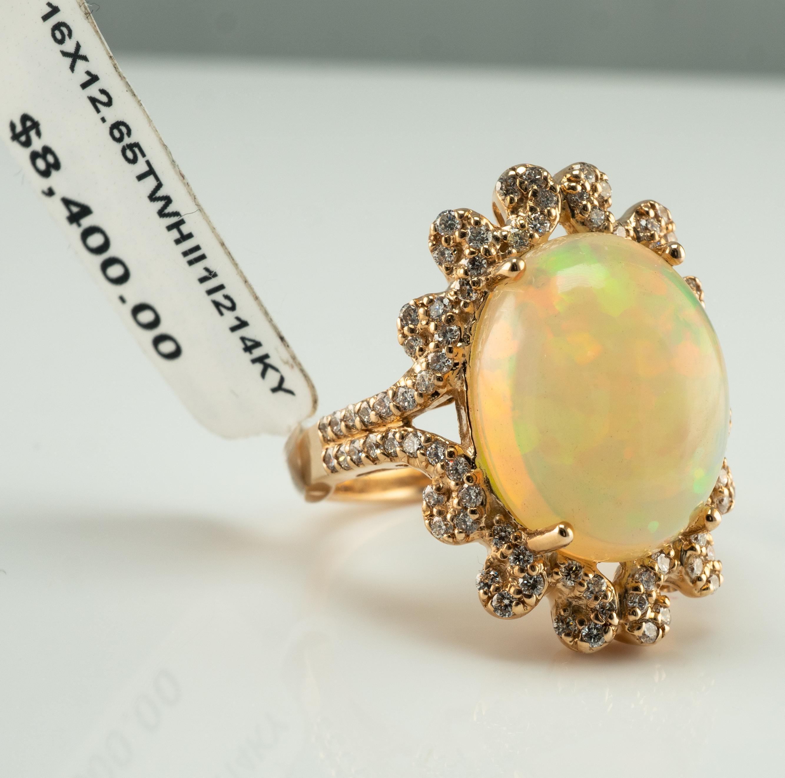 Diamond Crystal Opal Ring 14K Yellow Gold

This estate ring is made in solid 14K Yellow Gold and set with genuine Opal and diamonds.
The ring came to us from auction and still has an auction tag attached.
The center Earth mined Crystal Opal measures