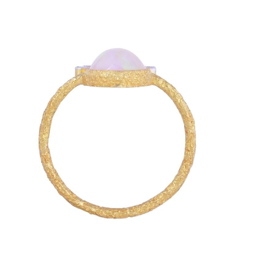 This ethereal ring is made with 18K yellow gold and features a showstopping opal gemstone crowned by 0.09 carat dazzling natural diamonds. The beauty of the ring enhances any outfit your pair it with and will act as a conversation-starter time and