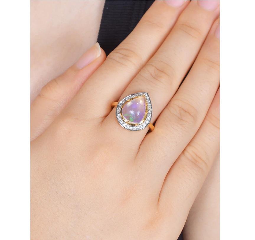An impressive diamond pave ring featured in 18k yellow gold, set with precious pear shape opal gemstone in prong setting. It has been outlined by diamonds to add spark to your look.  

Specifications

Dimensions: Length: 1.7 cm, Width: 1.5 cm
Gross