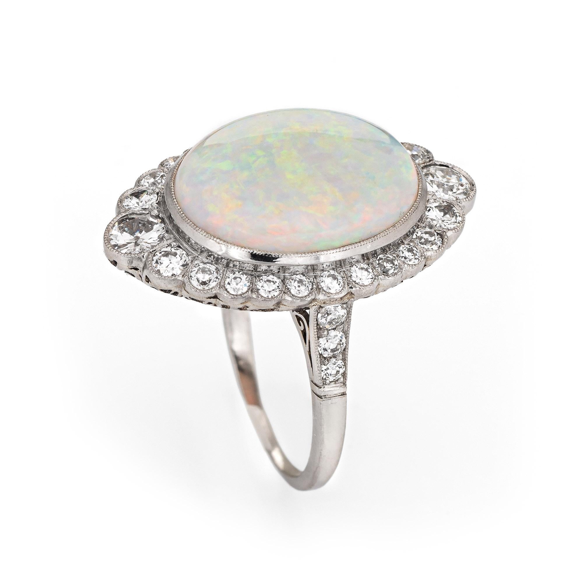 Stylish natural opal & diamond ring crafted in platinum. 

Natural opal measures 17mm x 13mm (estimated at 5.67 carats). The diamonds total an estimated 1 carat (estimated at H-I color and VS2-SI2 clarity). The opal is in excellent condition and