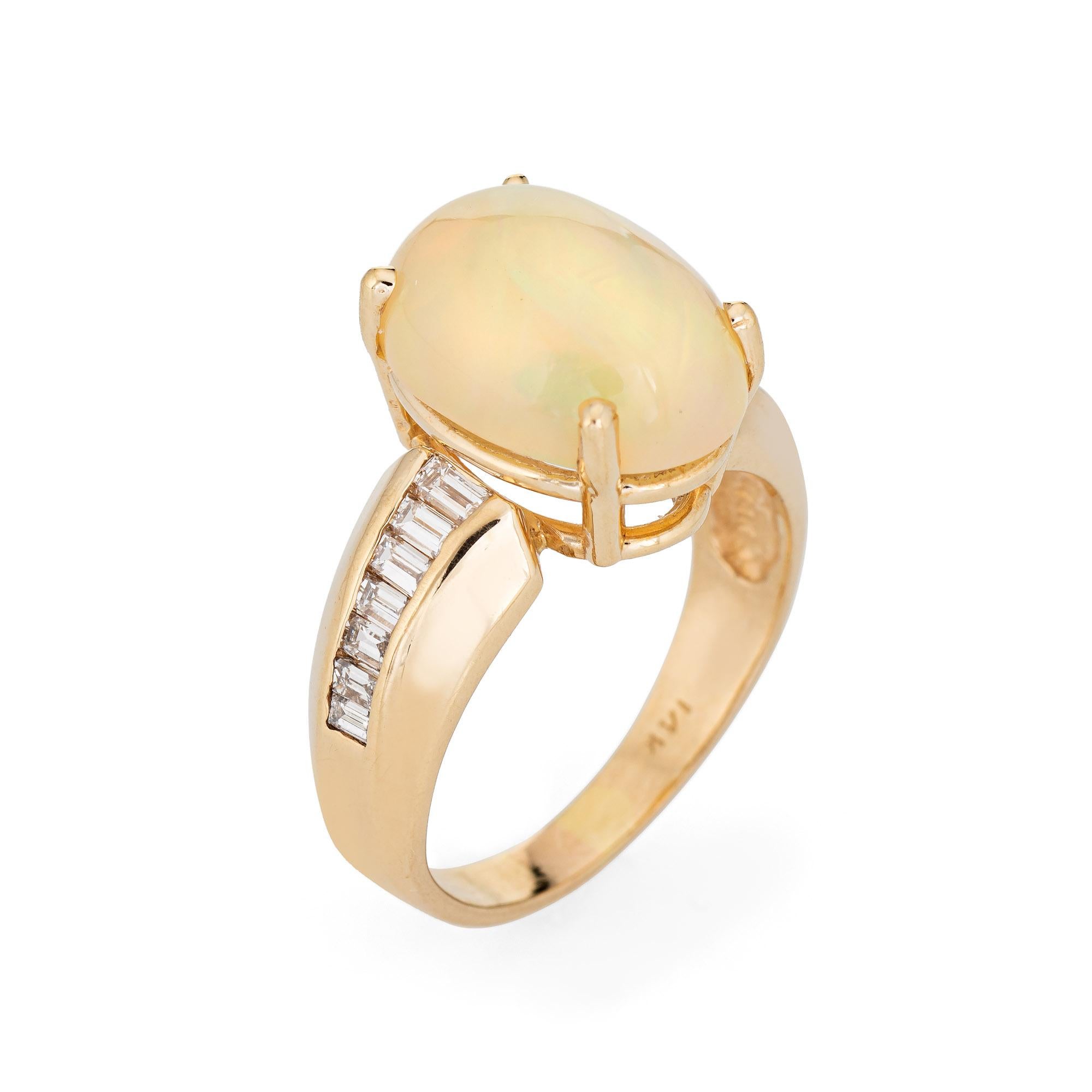 Stylish vintage opal & diamond cocktail ring crafted in 14 karat yellow gold. 

The natural opal measures 14mm x 10mm (estimated at 5 carats), accented with an estimated 0.75 carats of straight baguette cut diamonds (estimated at H-I color and