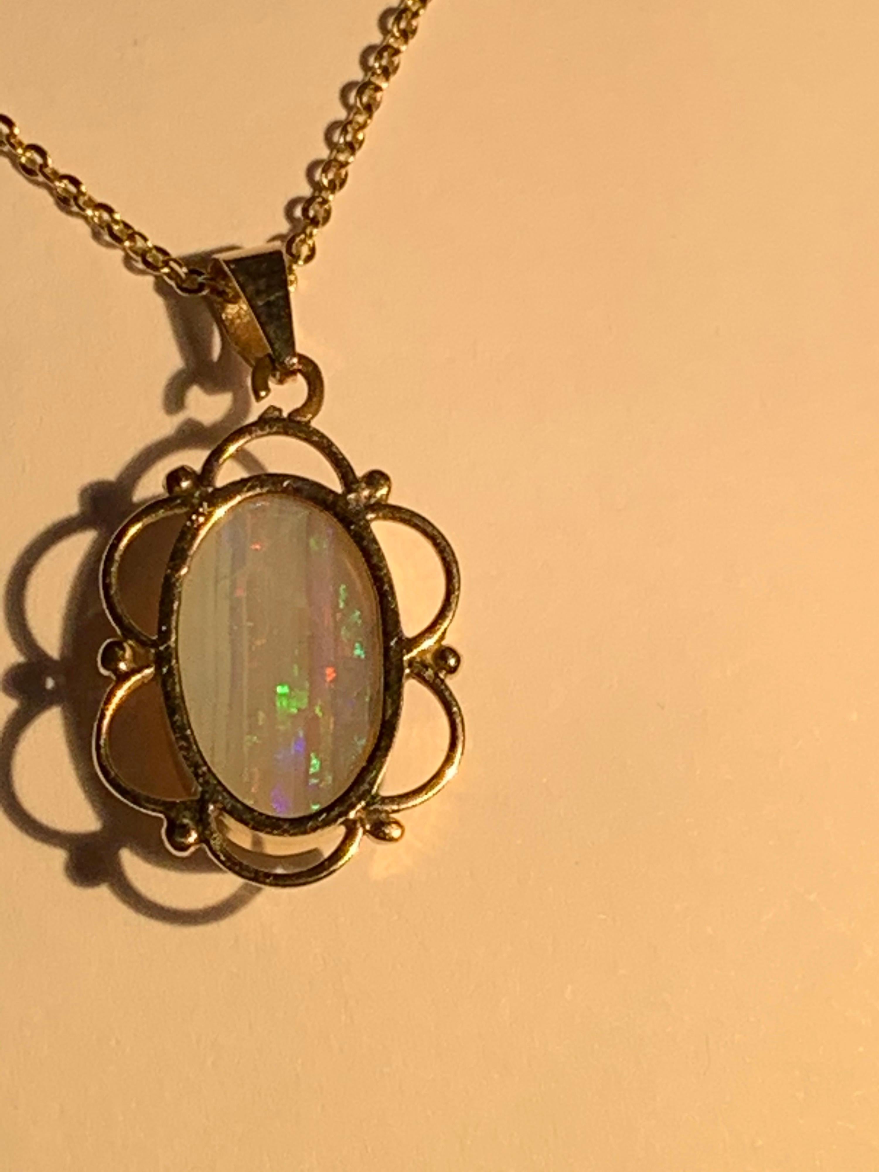 Contemporary Natural opal pendant set in 14 Karat Yellow Gold For Sale