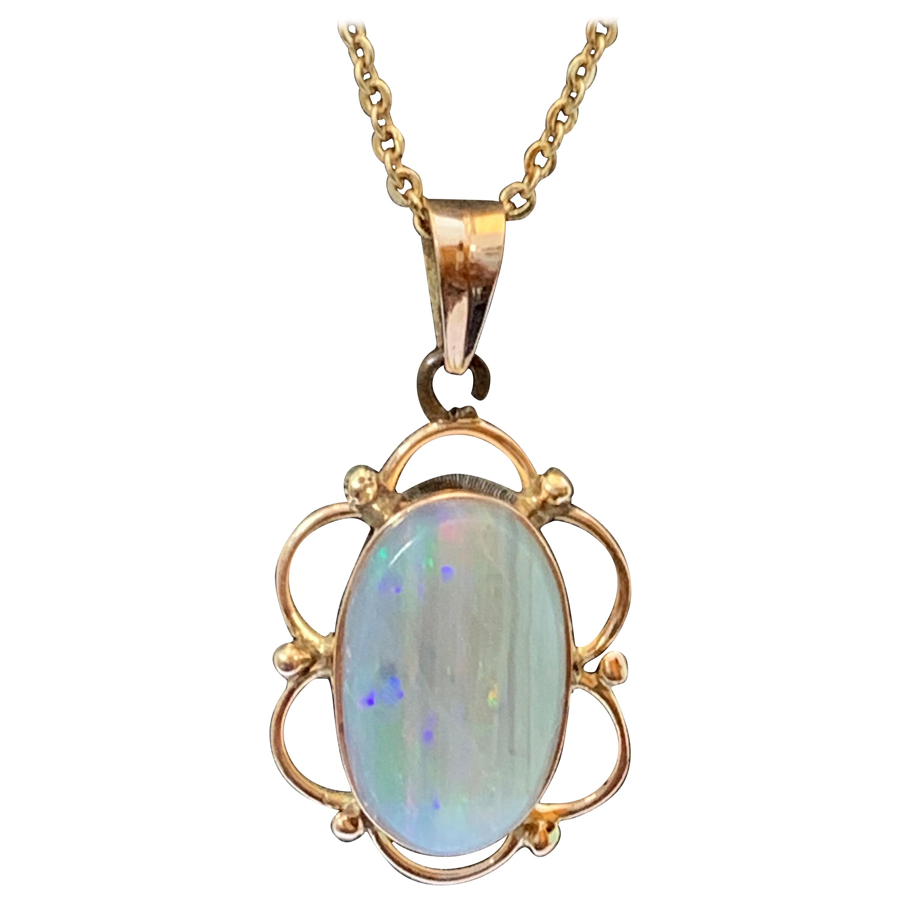 Natural opal pendant set in 14 Karat Yellow Gold For Sale